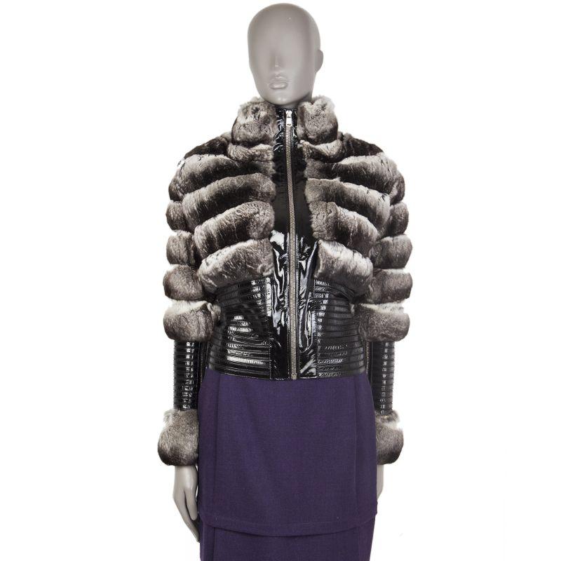 Jitrois high-nech fur jacket in black,, grey, and off-white chinchilla and black patent leather.  With patent strips panelled on black silk (60%), nylon (30%), and lycra (10%). Features zipper closures on the sleeves and on the front. Has been worn