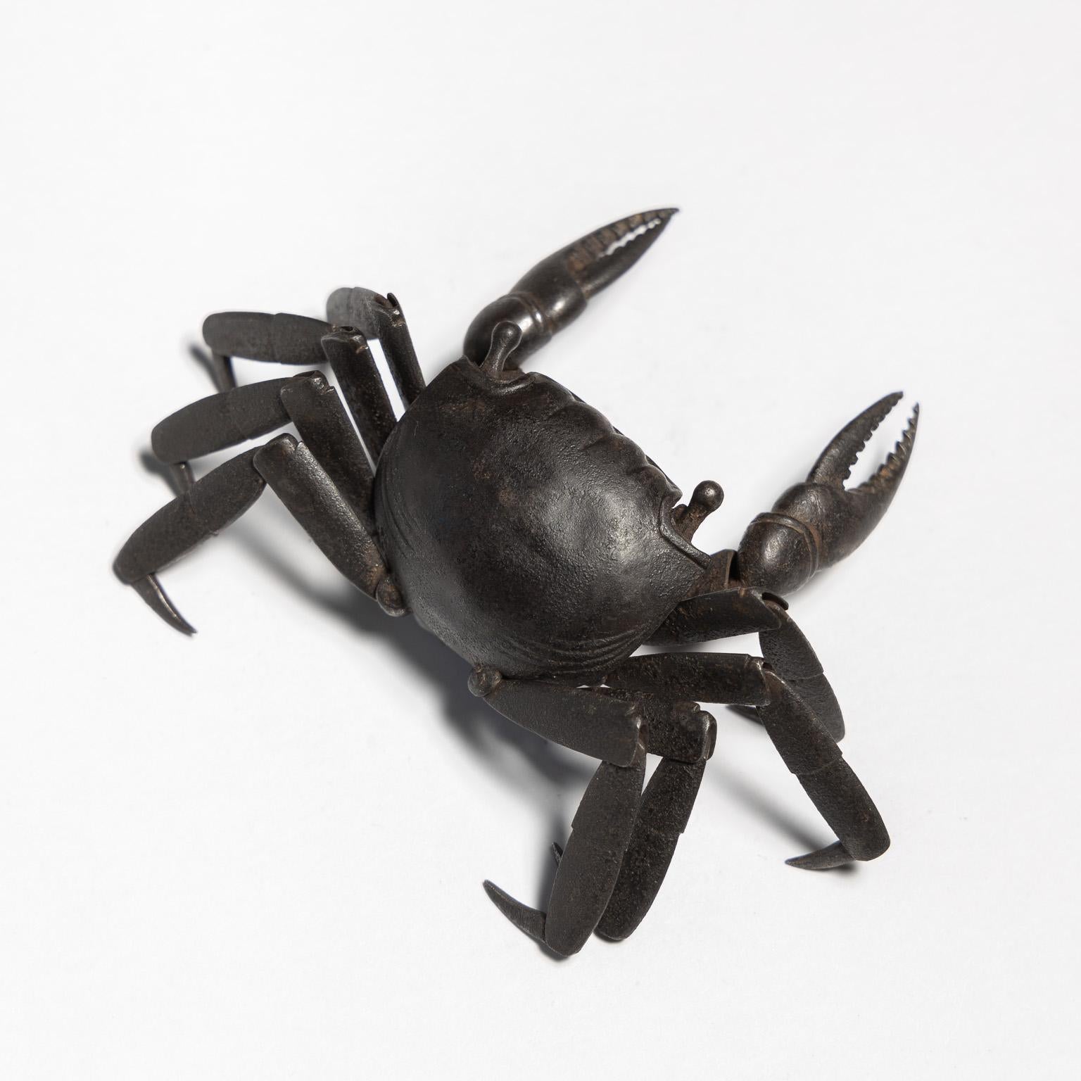 Jizai Okimono
A russet-iron articulated figure of a crab

Edo Period (1615 - 1867), 19th Century

Length: 15 cm with extended limbs

 

The iron crab is constructed of numerous hammered plates, jointed inside the body; the claws open and