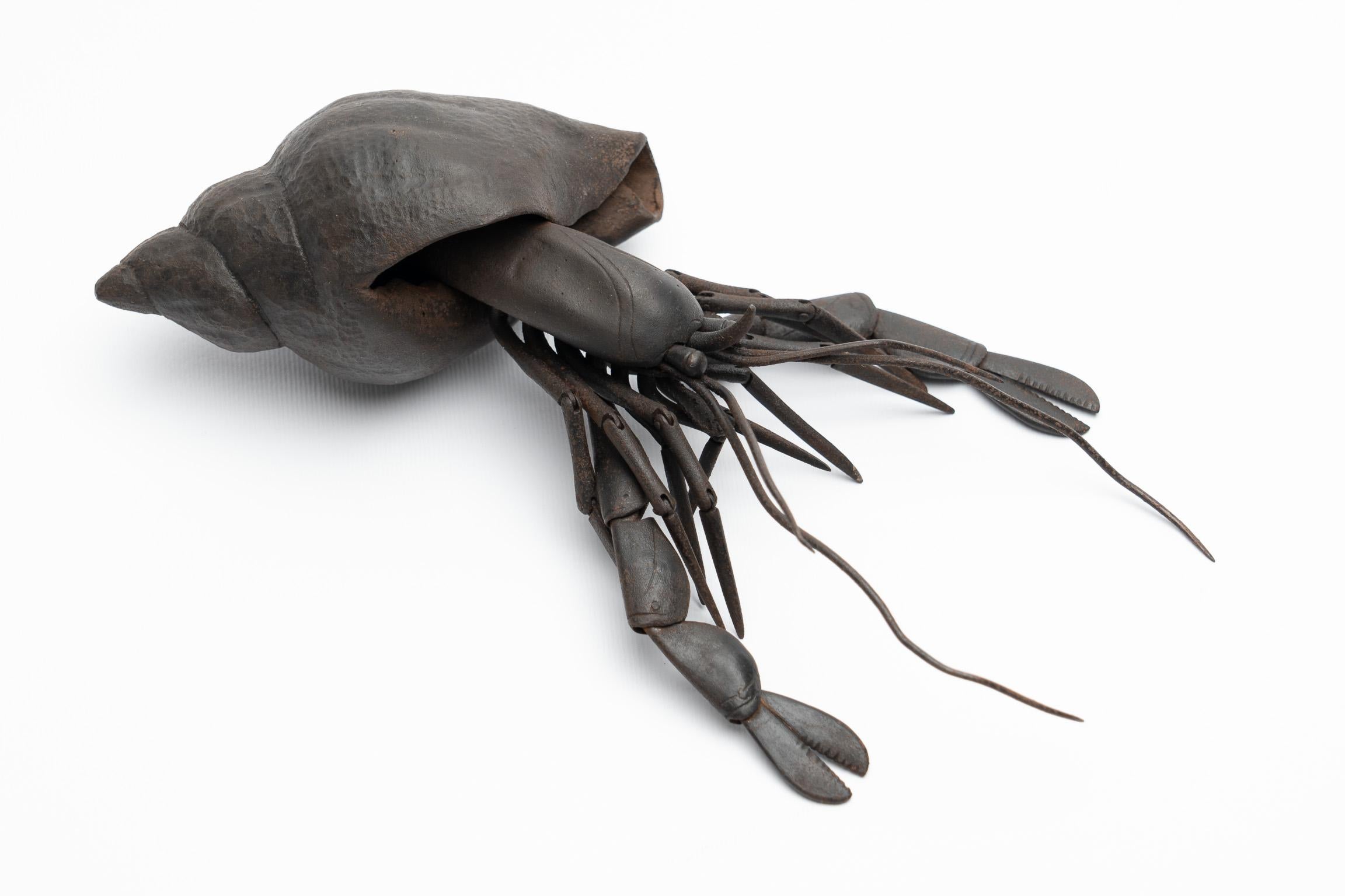 Jizai Okimono
A russet-iron articulated figure of a hermit crab

Myōchin school, Edo Period

18th-19th century

Length: 19.5 cm

 

With a large, realistically rendered, spiralling top shell, the iron hermit crab is constructed of numerous hammered