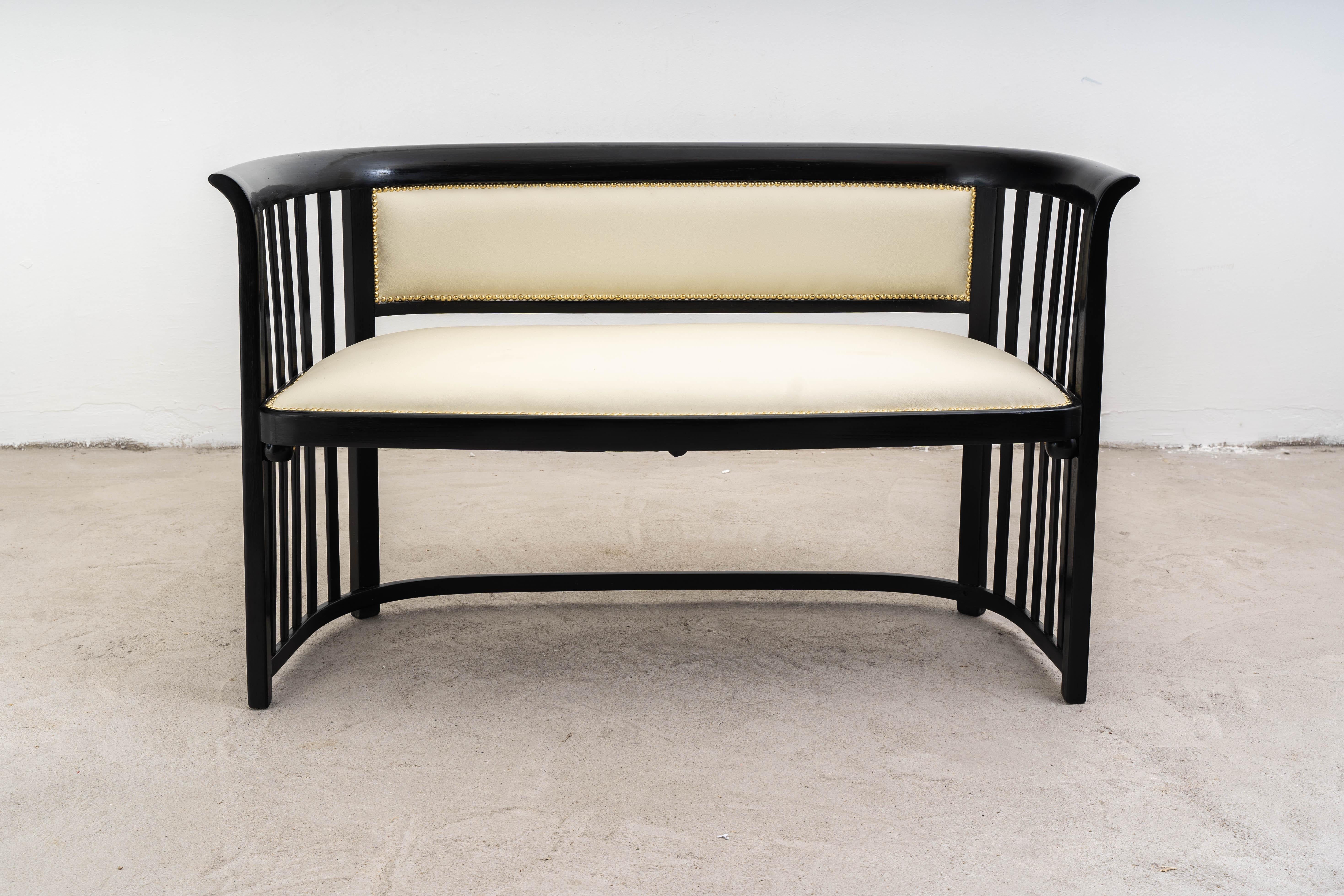 This description details a piece of living-room furniture by renowned Austrian designer and architect Josef Hoffmann (1870–1956) in collaboration with Jacob & Josef Kohn, a furniture manufacturer based in Vienna. This set includes a sofa and two