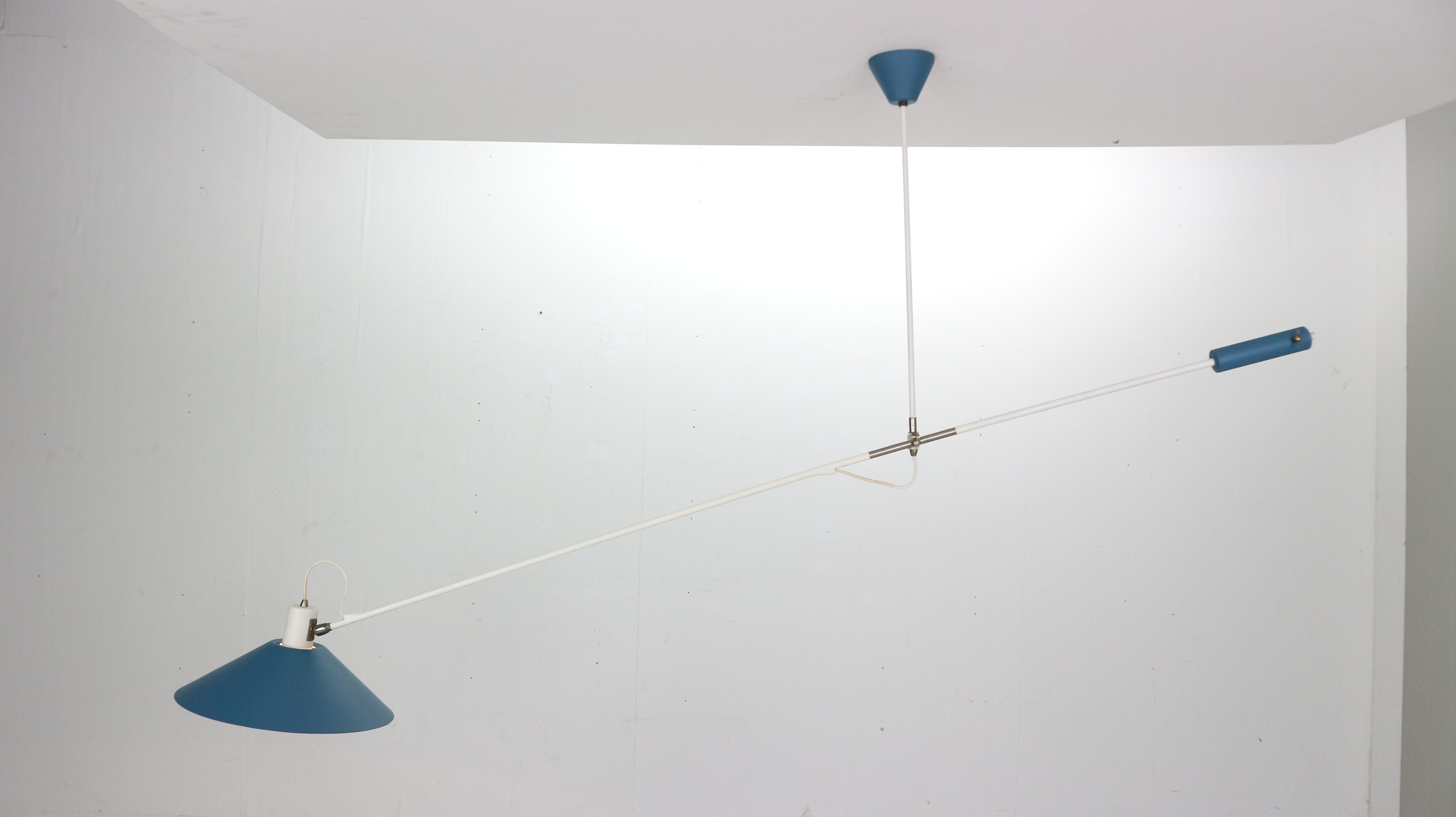 First edition sculptural counter balance ceiling lamp designed by JJM Hoogervorst for Anvia Almelo, Holland, 1957.
This amazing lamp has a white lacquered arm and blue lamp shade and its weight. The lamp balances in any wanted position by changing