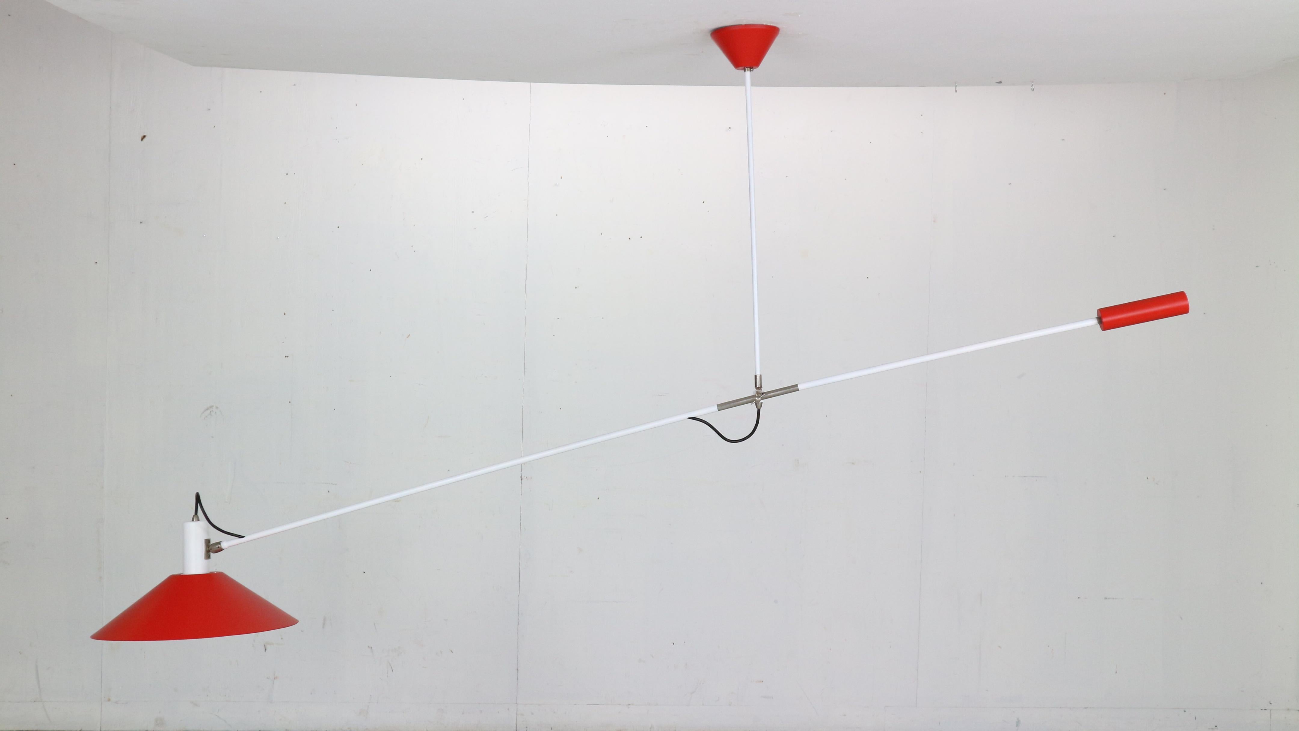 First edition sculptural counter balance ceiling lamp designed by JJM Hoogervorst for Anvia Almelo, Holland, 1957. 

This amazing lamp has a white lacquered arm and red shade and weight (which has been professionally repainted in it's original red