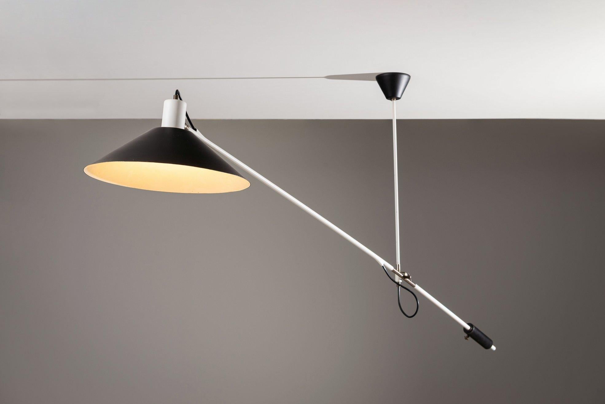 Iconic counterbalance ceiling lamp designed by J.J.M. Hoogervorst for Anvia, The Netherlands, in 1957. A quintessential piece of Dutch mid-century industrial design, it showcases Hoogervorst’s refined sense of proportion and functionality, blending