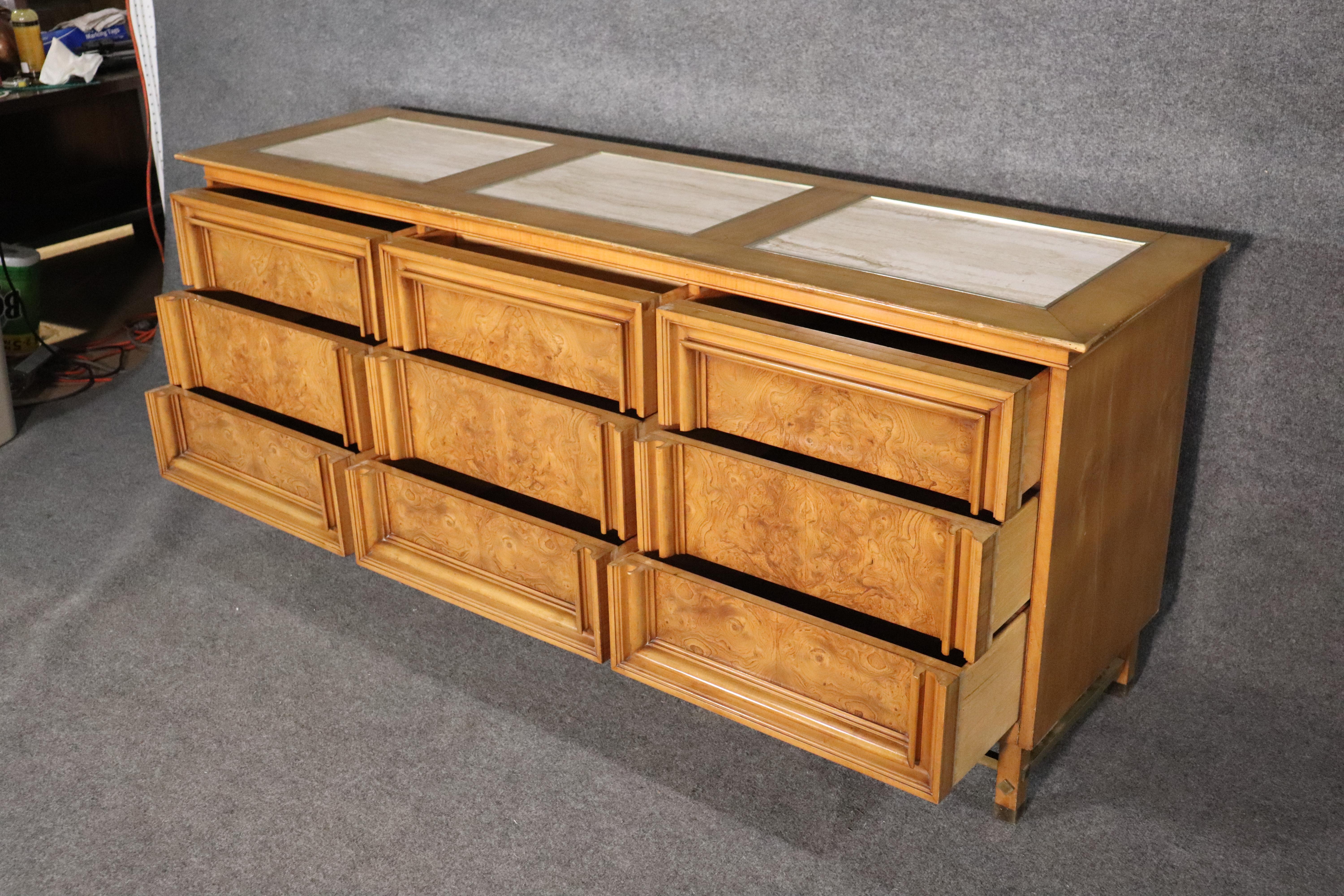 Stunning midcentury dresser made by JL Metz Company. Featuring weathered cherry wood with accenting burl front drawers, inset travertine top and patina brass stretchers.
Please confirm location NY or NJ.