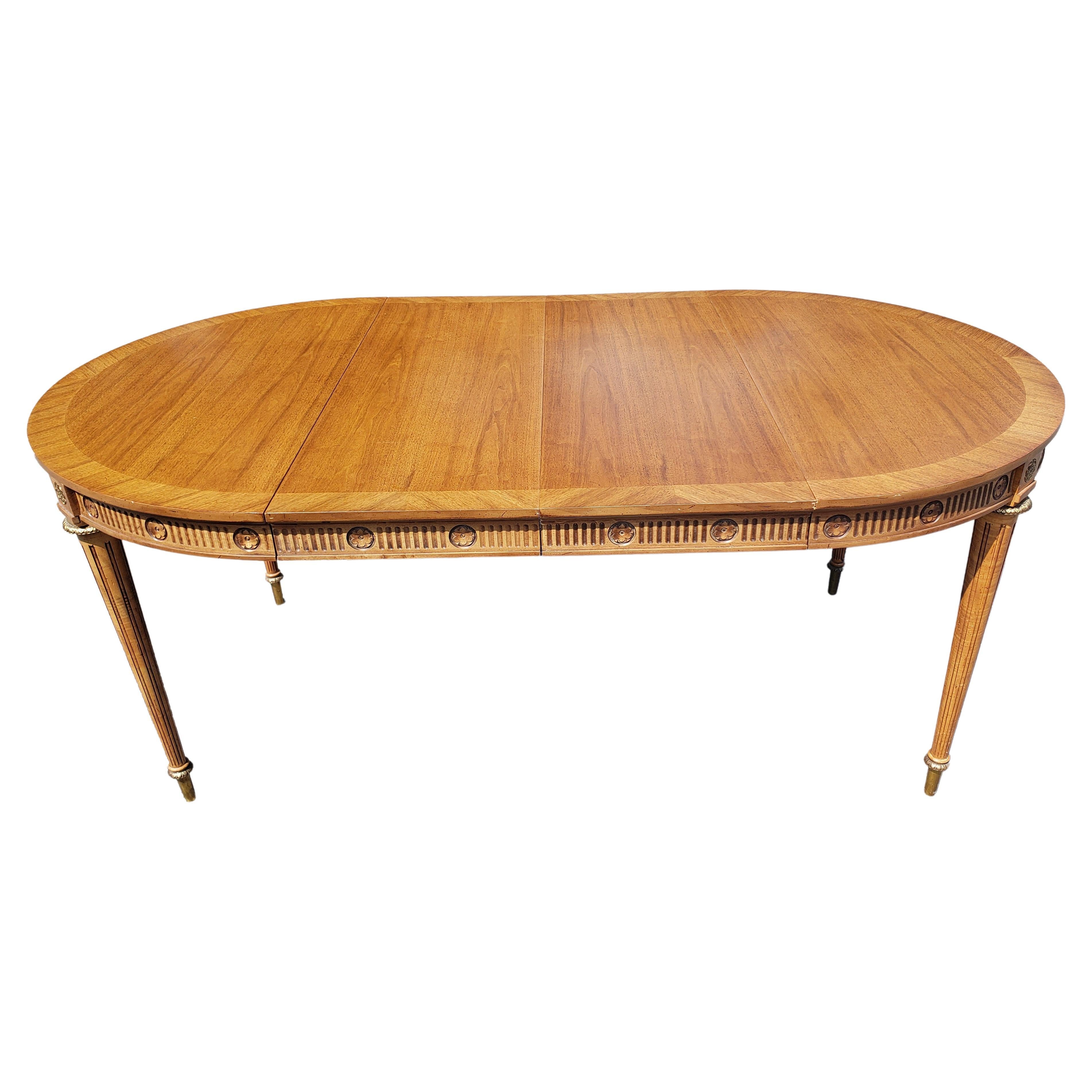 This high quality Dining Table with Two Leaves is made out of French Walnut wood,veneer and cast brass mounted ornaments. The table is made by J. L. Metz and it is labeled. Table has been recently refinished and is in great condition. It has a