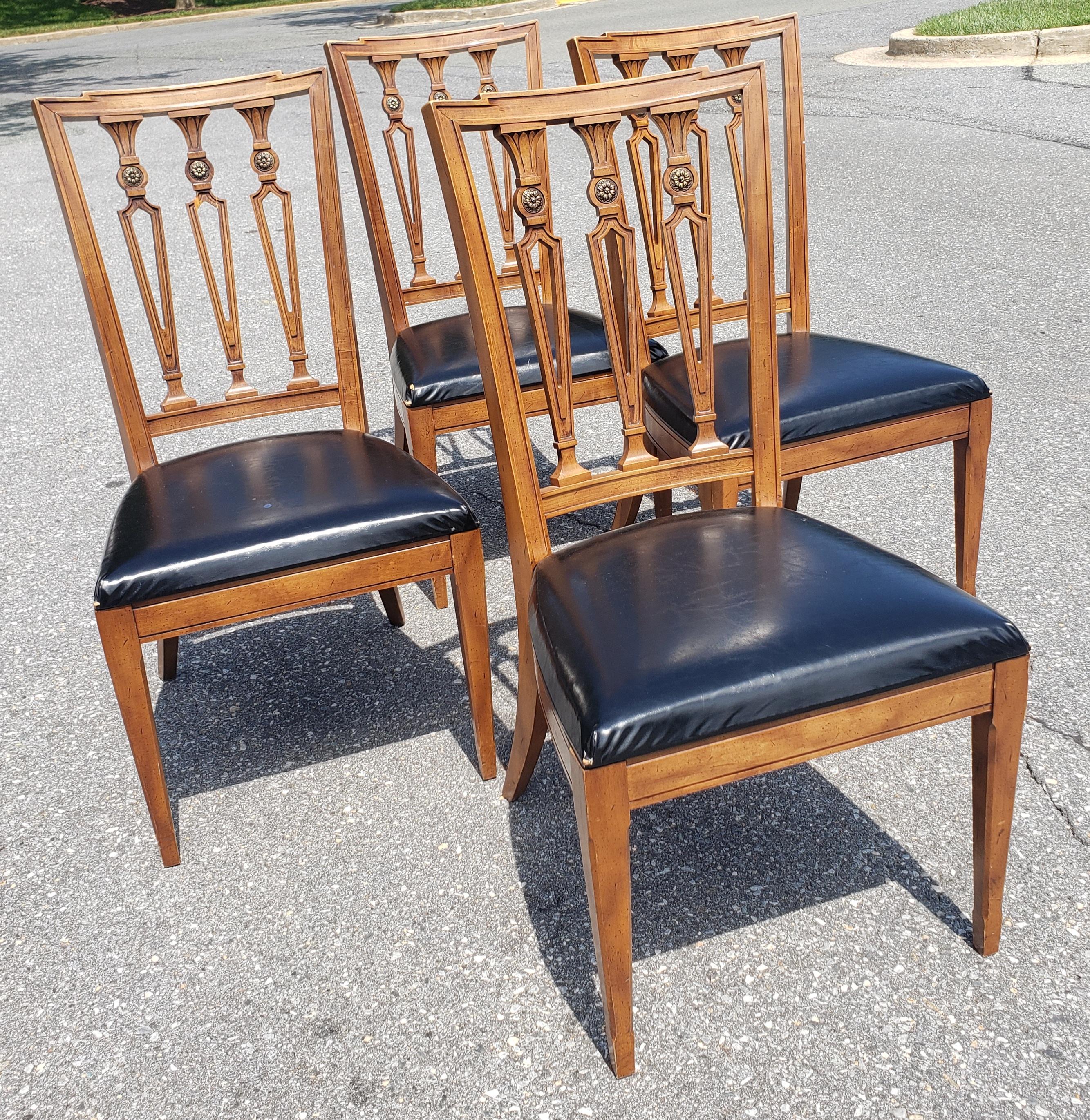 This set high quality Dining chairs is made out of French Walnut wood and cast brass mounted medaillion ornaments and brand new Black Upholstered Top Grain Cow Leather seats. The chairs were made by J. L. Metz. The have a light stain finish to the