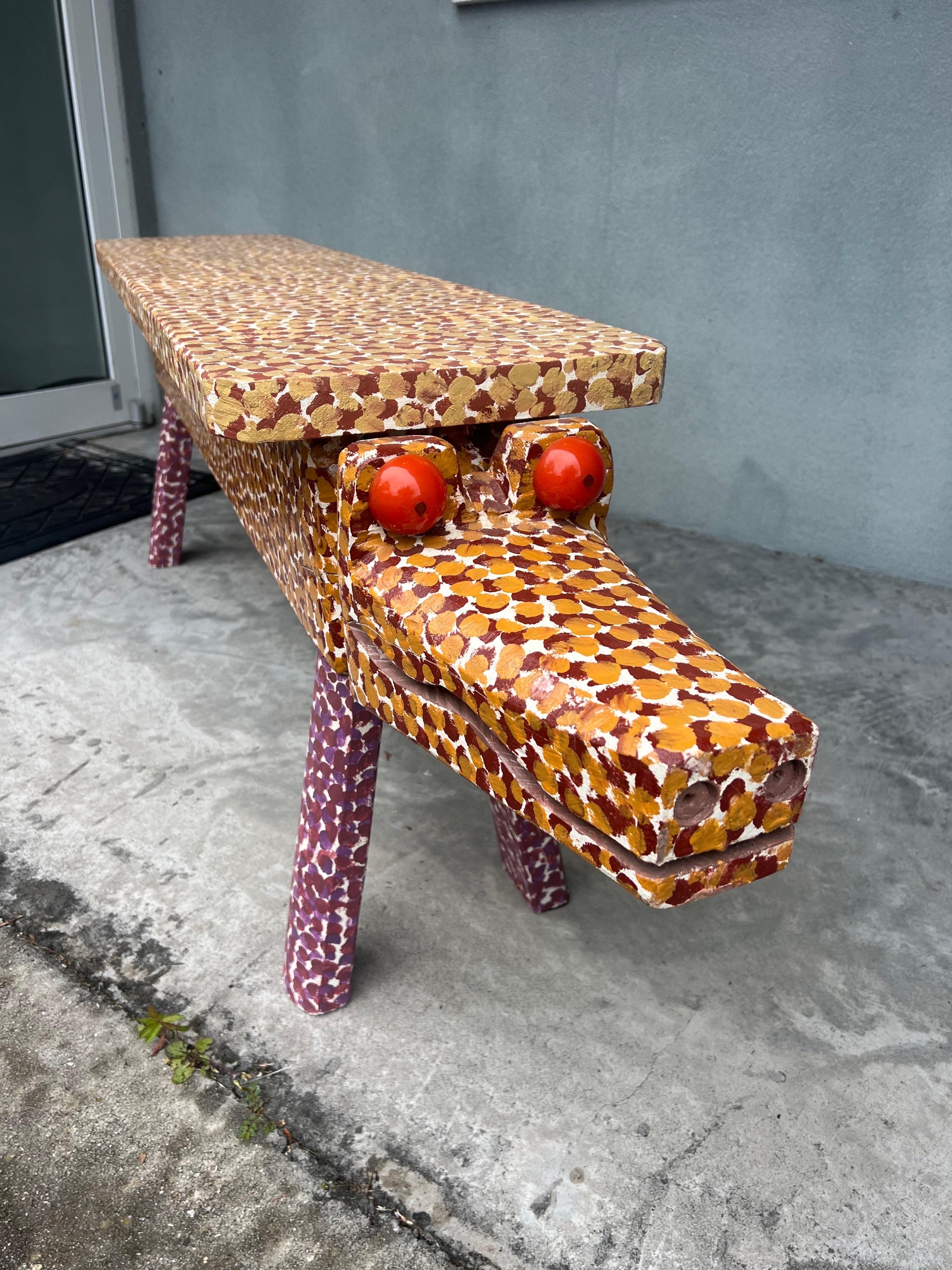 Excellent whimsical double headed painted wood sculpture/bench by the late J.L. Nipper. The paint style is very much in the style of JL Nipper, the self proclaimed chainsaw sculptor. J.L. Nipper (Tennessee, 1935-2021). This piece is not signed as