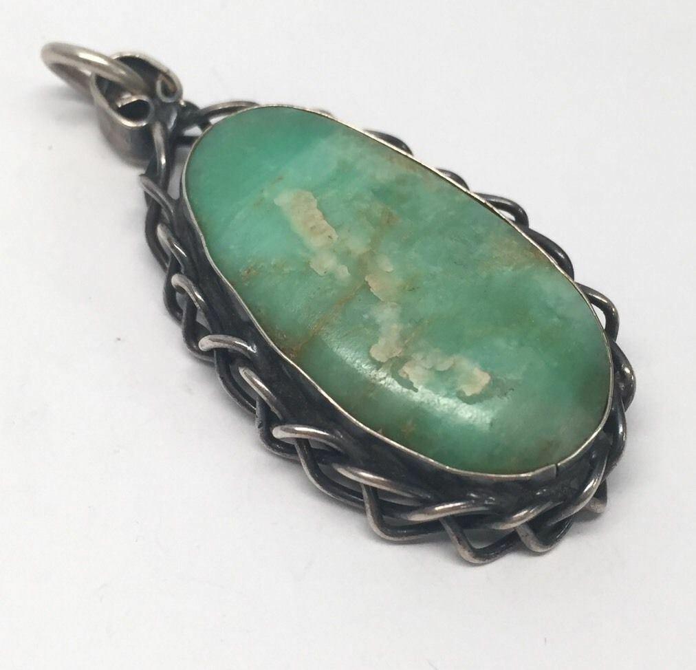 Sterling silver green turquoise pendant by artisan JM.

Marking: STERLING JM.

Measures approx. 2 1/16