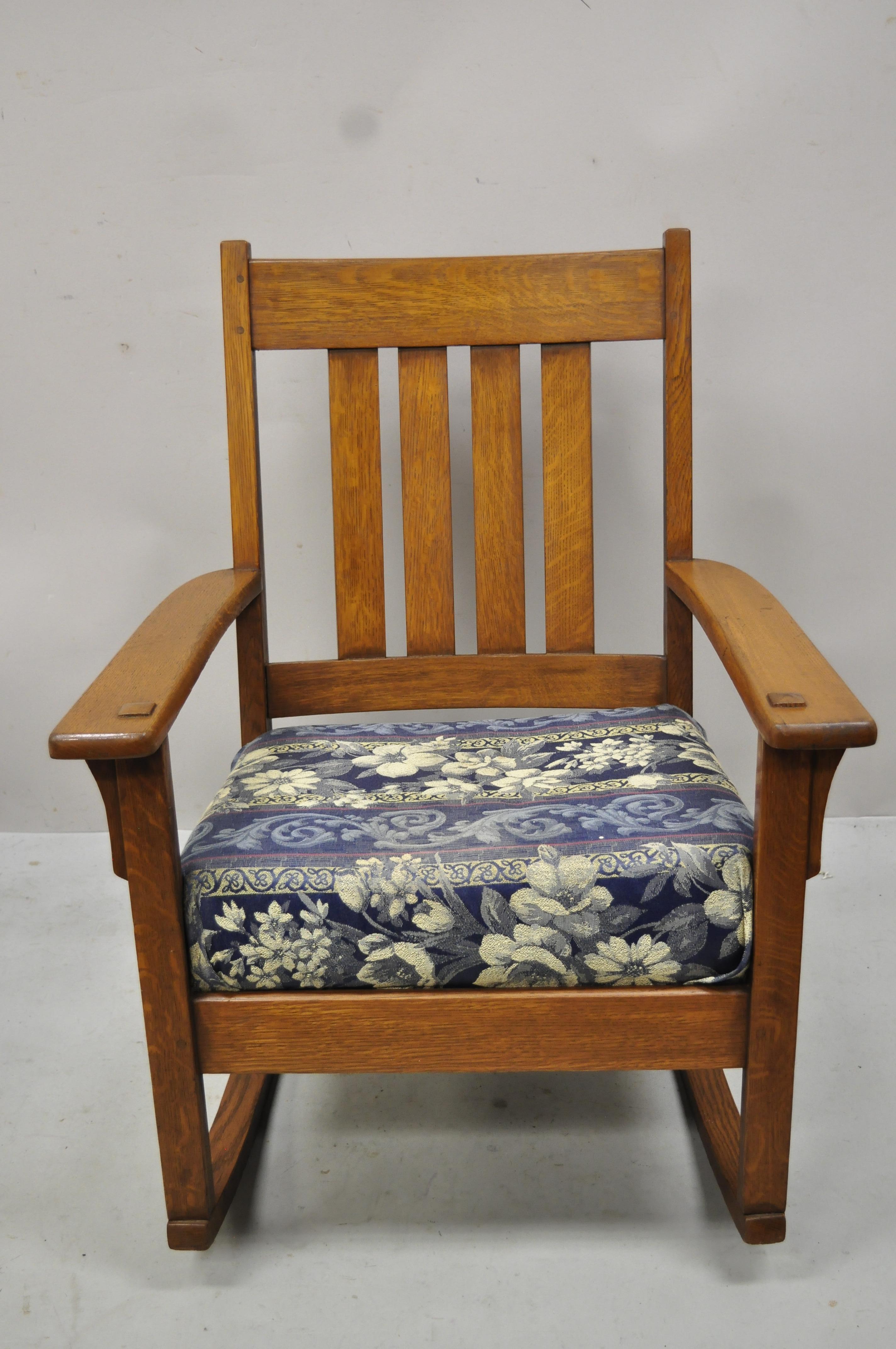 J.M. Young & Sons Antique Mission Oak Arts & Crafts Rocker rocking chair. Item features solid wood construction, beautiful wood grain, original label, very nice antique item, quality American craftsmanship. Circa Early 1900s. Measurements: 35