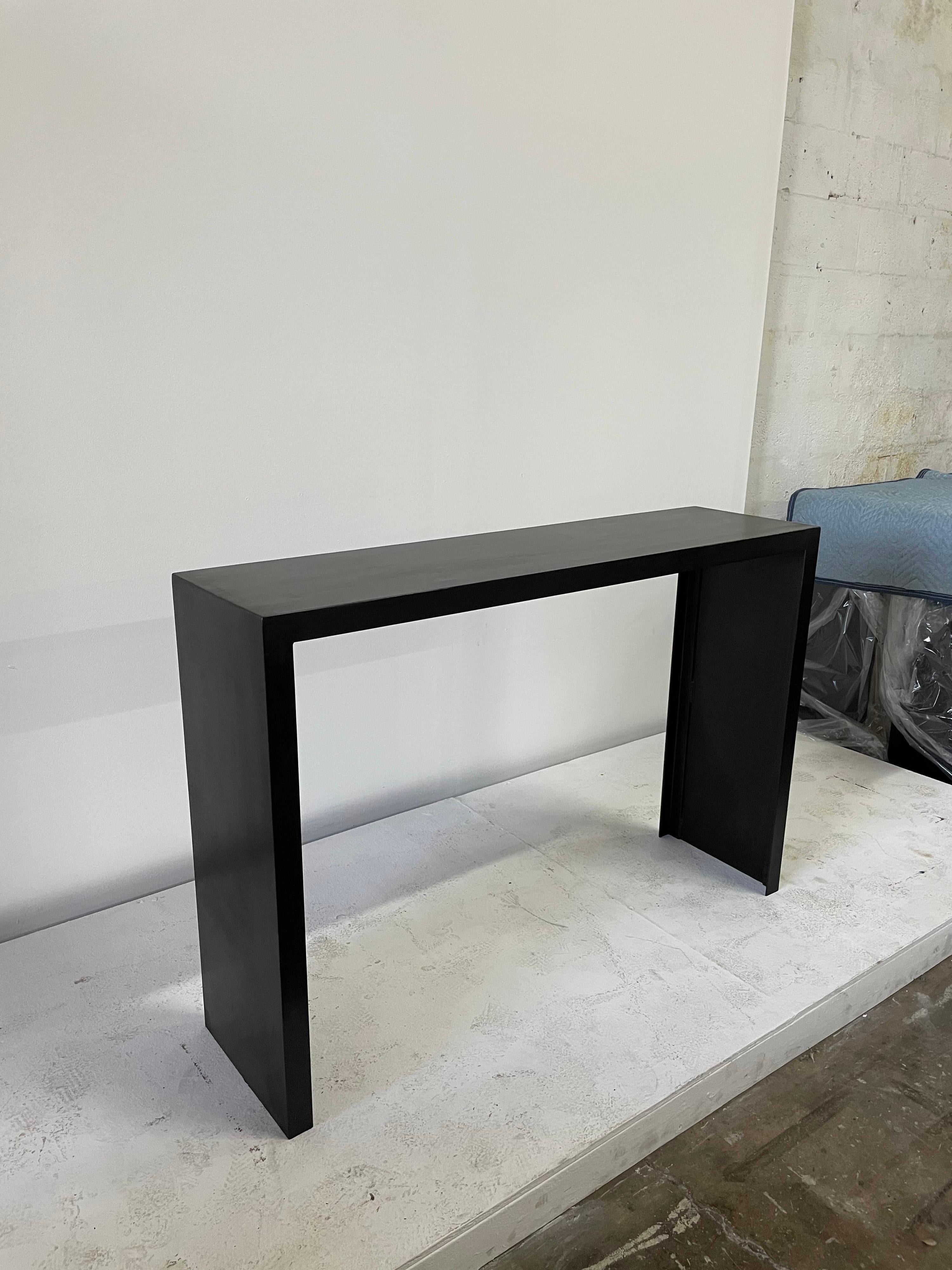49 inch Long classic JMF style heavy iron console table. Showing Industrial metal signs and spots with matte dark wax finish. Not a perfect consistent finish which is how it was created and meant to be. Made and designed for Gustavo Olivieri Studio.