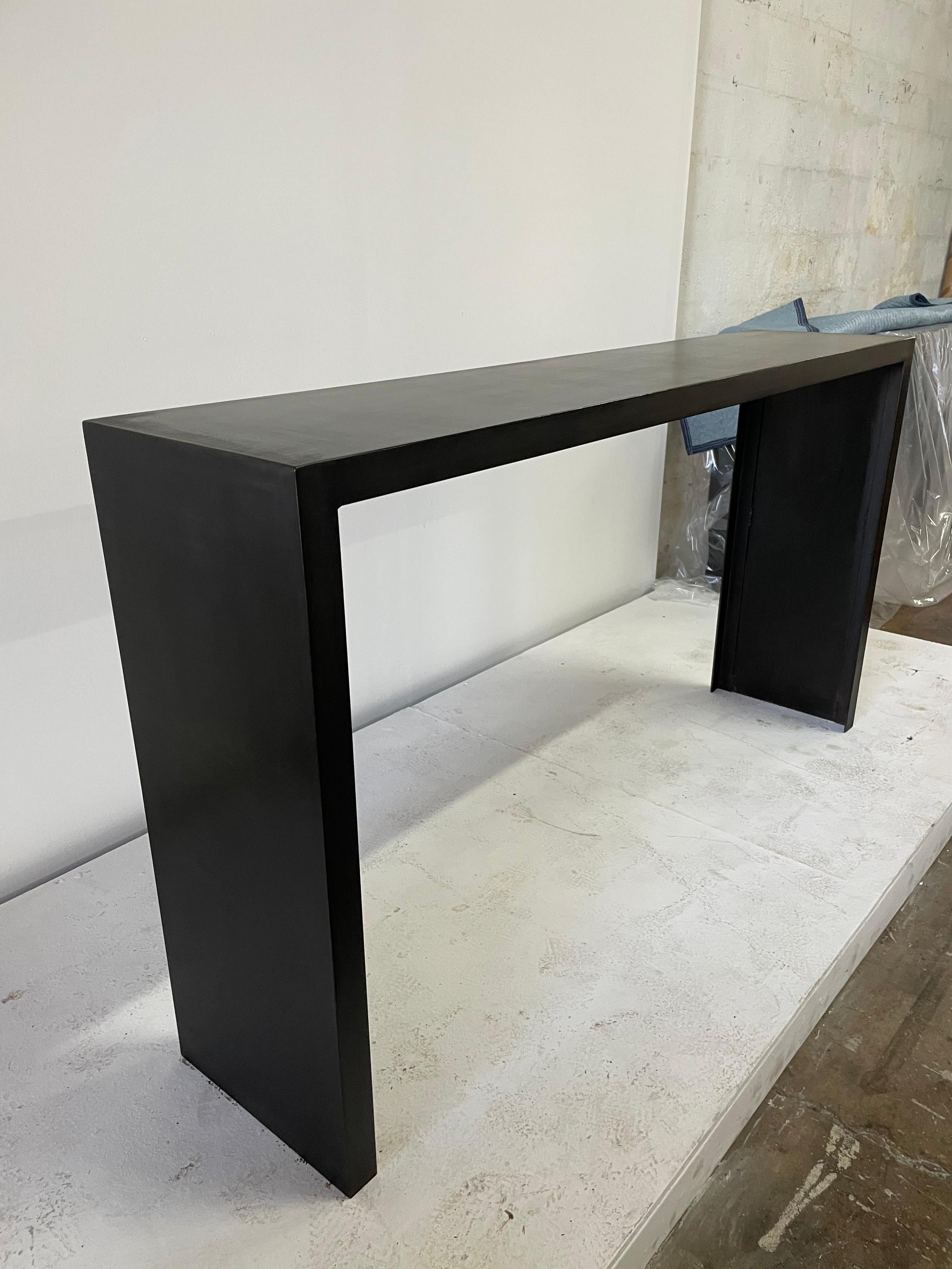 66 inch long Classic JMF style heavy iron console table. Showing Industrial metal signs and spots with matte dark wax finish. Not a perfect consistent finish which is how it was created and meant to be. Made and designed for Gustavo Olivieri Studio.