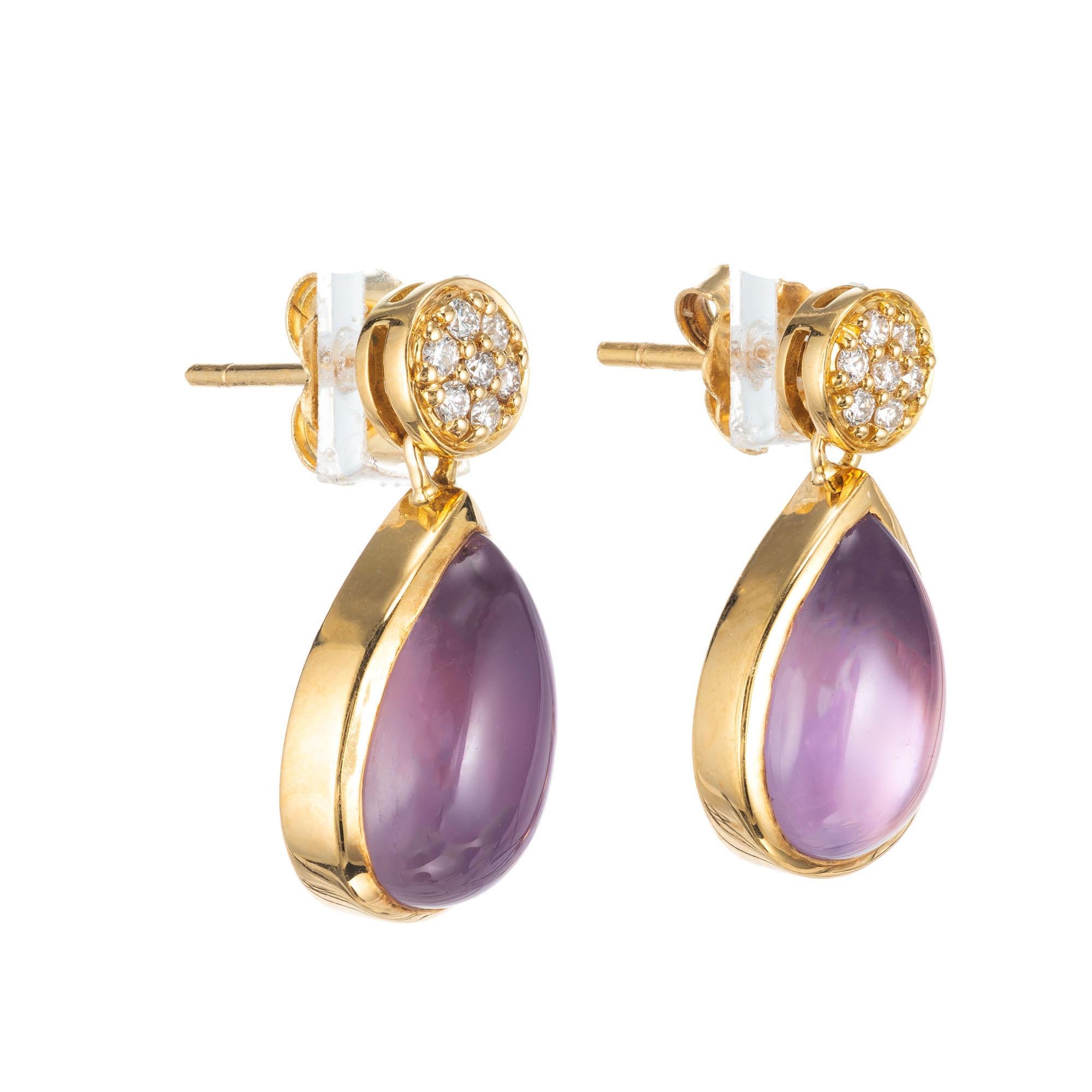 Designer JMP amethyst and diamond dangle earrings. Pave diamond cluster tops. Cabochon pear shaped  Amethyst over a Mother of Pearl for a Moonstone like glow, set in 18k yellow gold. 

14 round full cut diamonds, approx. total weight .14cts, G, VS
2