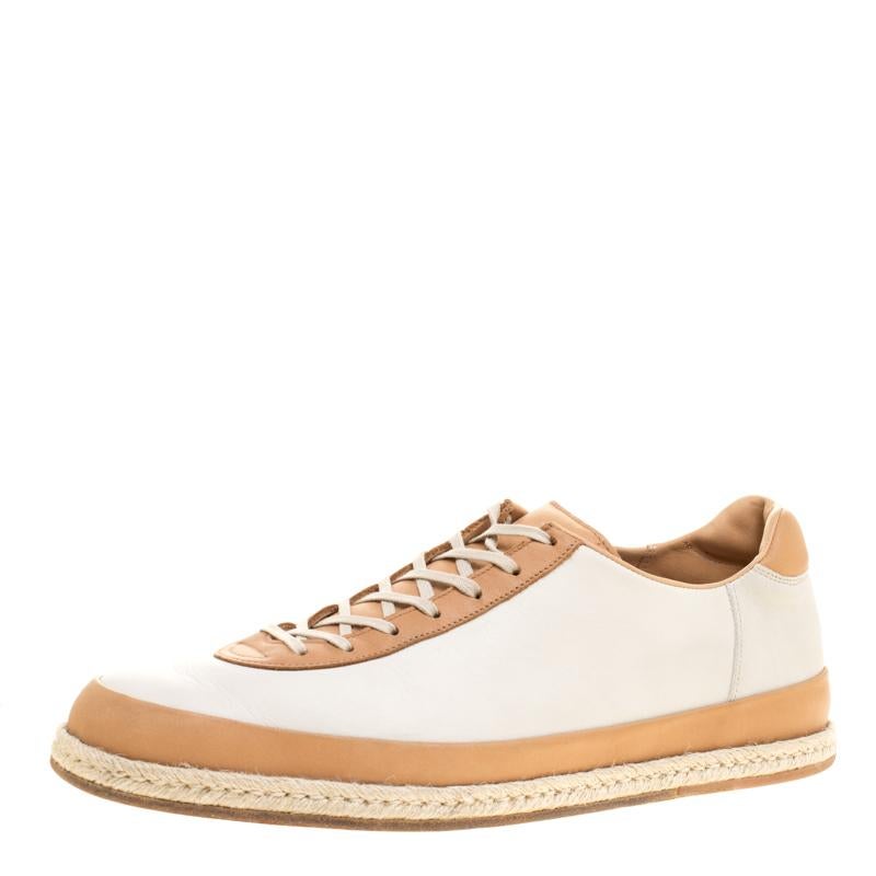 These J.M.Weston sneakers are simple yet stylish. They've been crafted from leather in two shades and designed with laces on the vamps, espadrille midsoles and leather insoles. These sneakers are just perfect to ace one's casual style.

Includes: