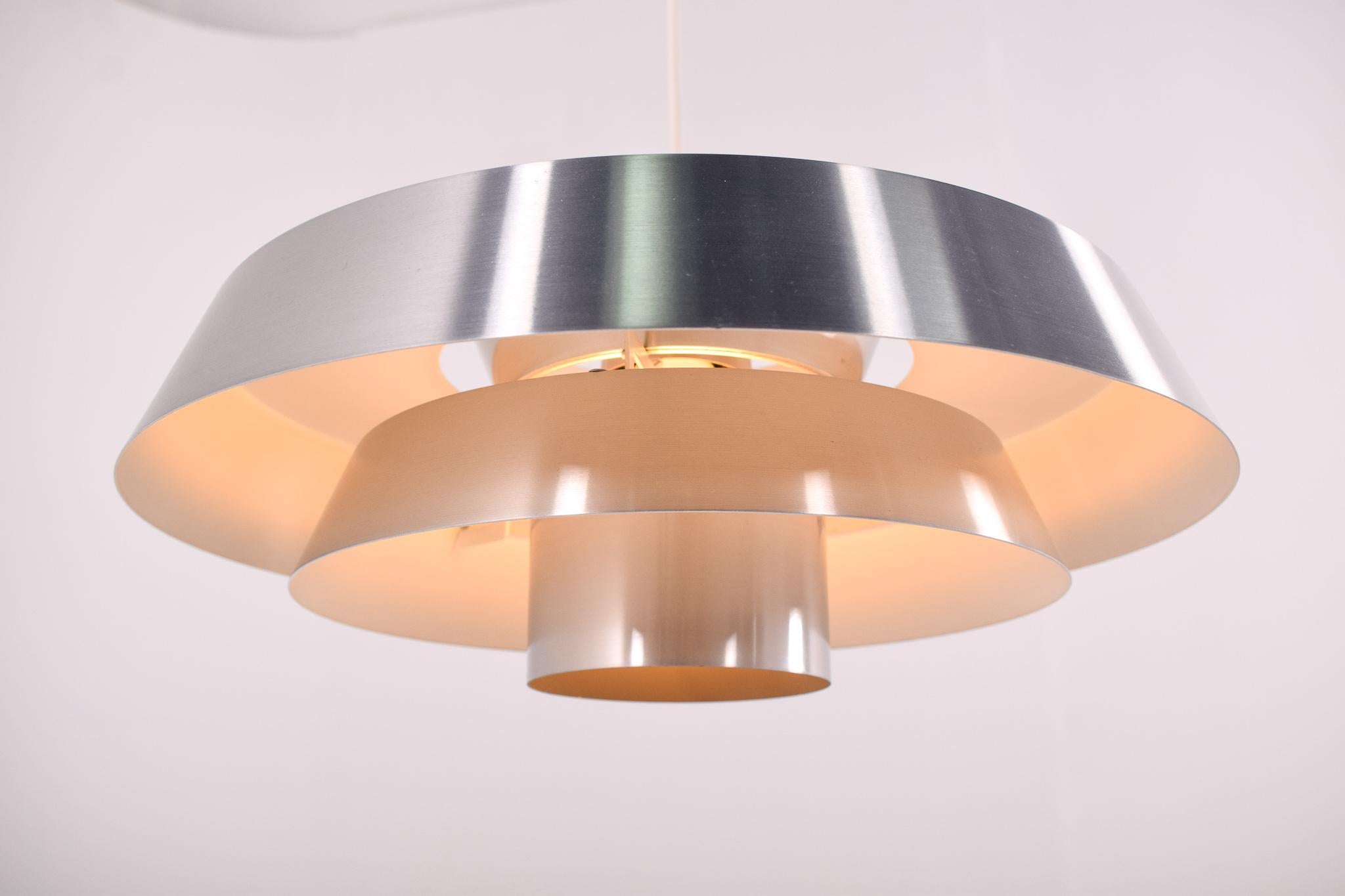 Pendant, model Nova, designed in the 1960s by Jo Hammerborg, main designer of Danish lighting manufacturer Fog & Mørup in the 1960s. The model was produced in three different metals: copper, brass, and aluminum. This one is made from aluminium.