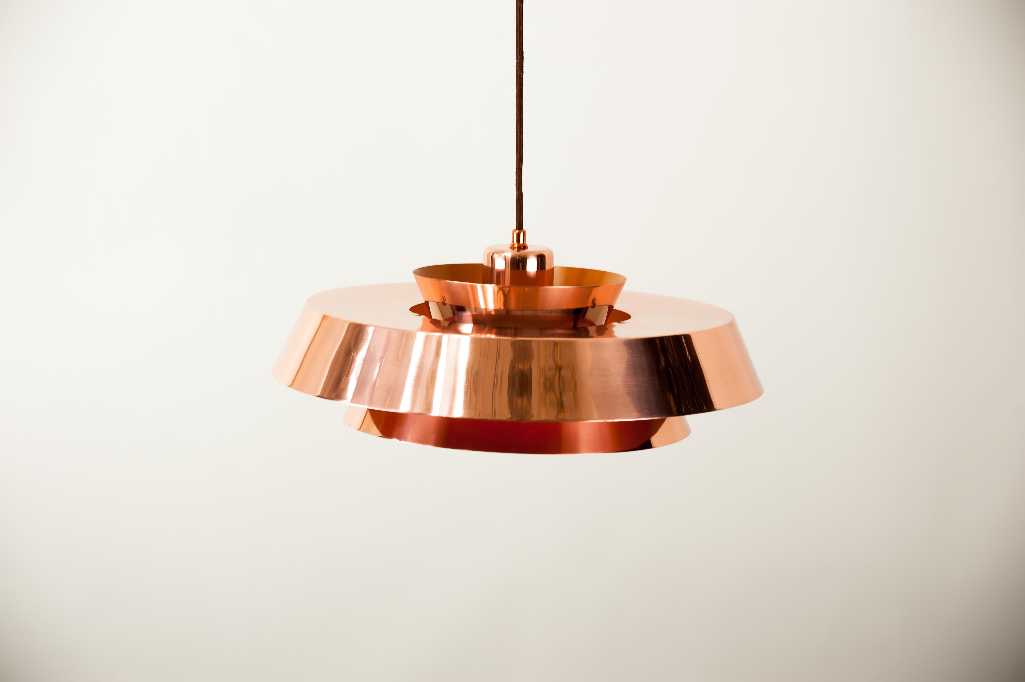 Jo Hammerborg Nova copper pendant for Fog & Mørup, 1960s.
Polished and stove enameled
We can arrange to adjust the height of this impressive chandelier to any length you wish as a free service.