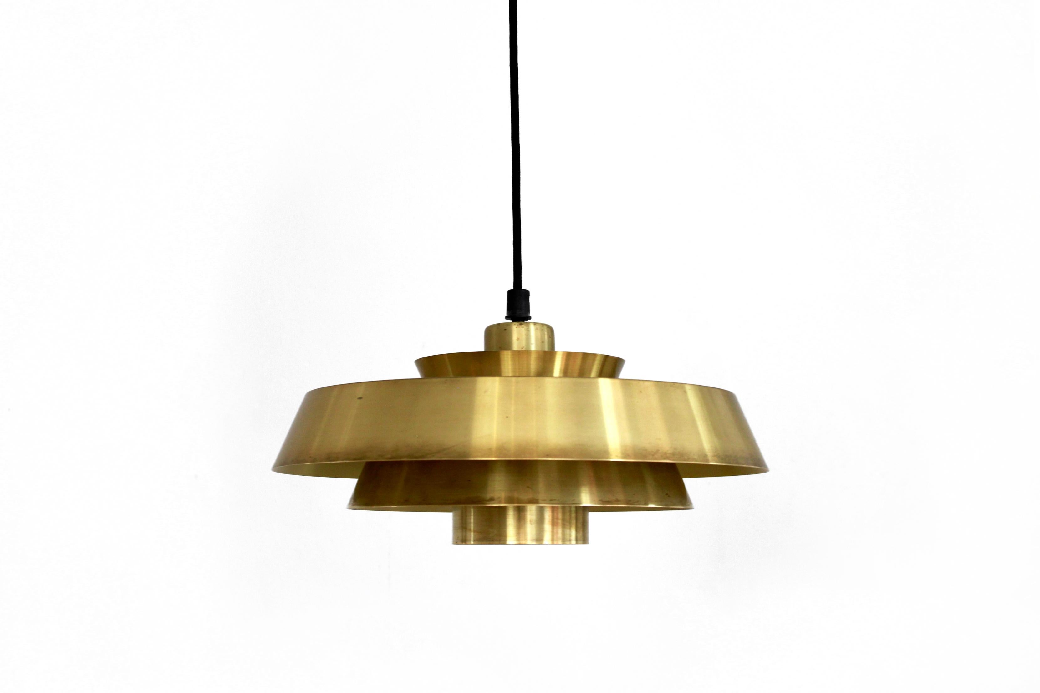 Vintage timeless Jo Hammerborg hanging lamp with model name 'Nova'. The lamp is made of solid brass, which makes this lamp of a very high quality. Even if this lamp is off, it is a beautiful eye-catcher for any interior. The diameter of this lamp is