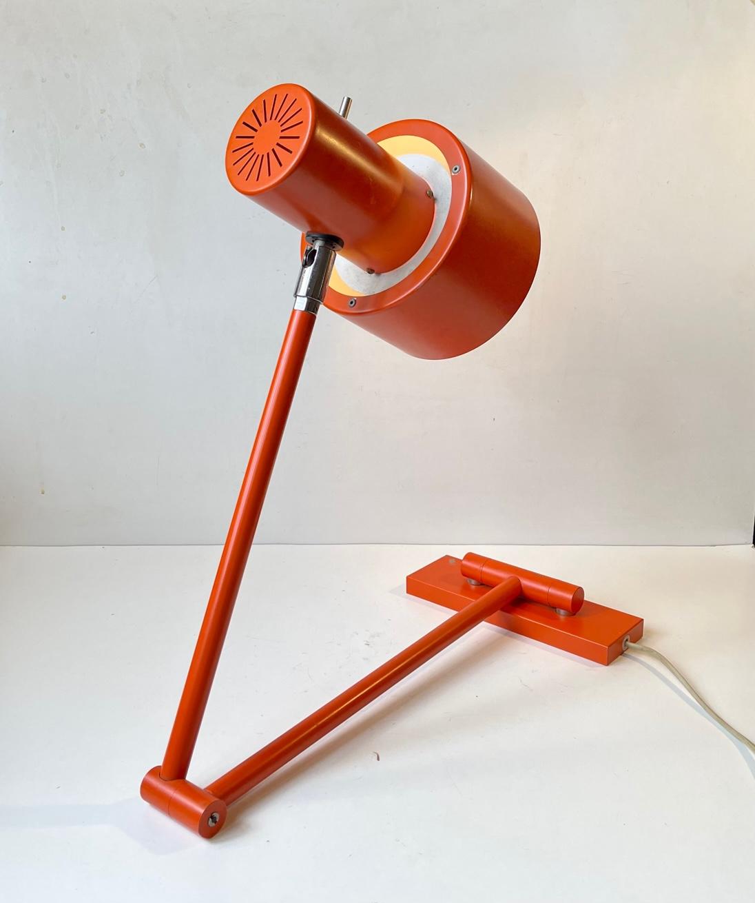 A rare swing arm wall sconce or table lamp in its original orange color. It is called Skala and was designed in 1969 by Jo Hammerborg and manufactured by Fog & Mørup in Denmark from 1969-75. Its a very versatile light suitable for a desk lamp,