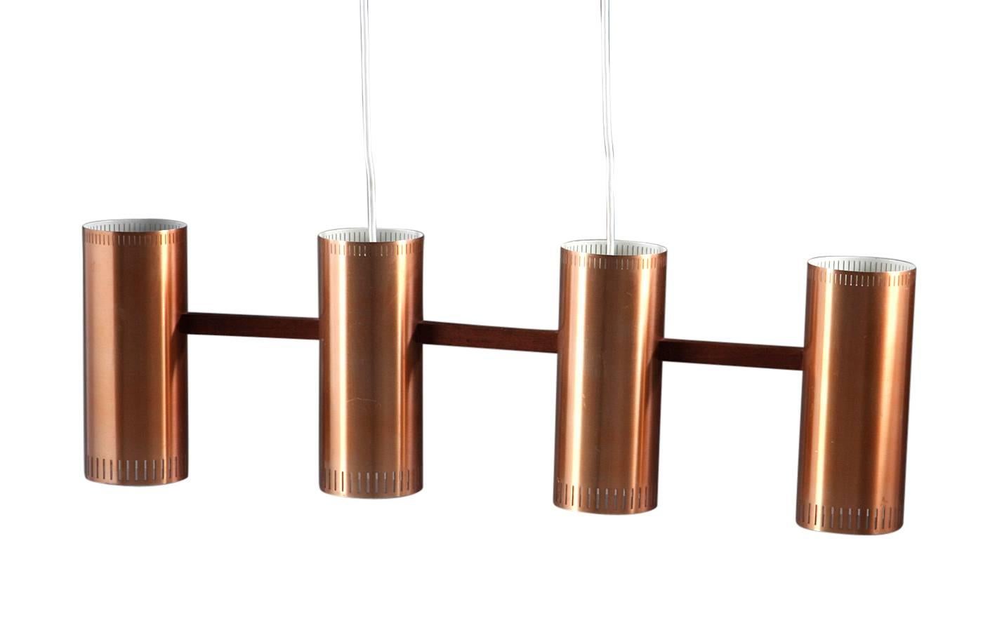 Jo Hammerborg, made of copper, suspension and teak wood frame. Made by Fog & Mørup.
Measures: H 25/110 cm., L 82 cm.