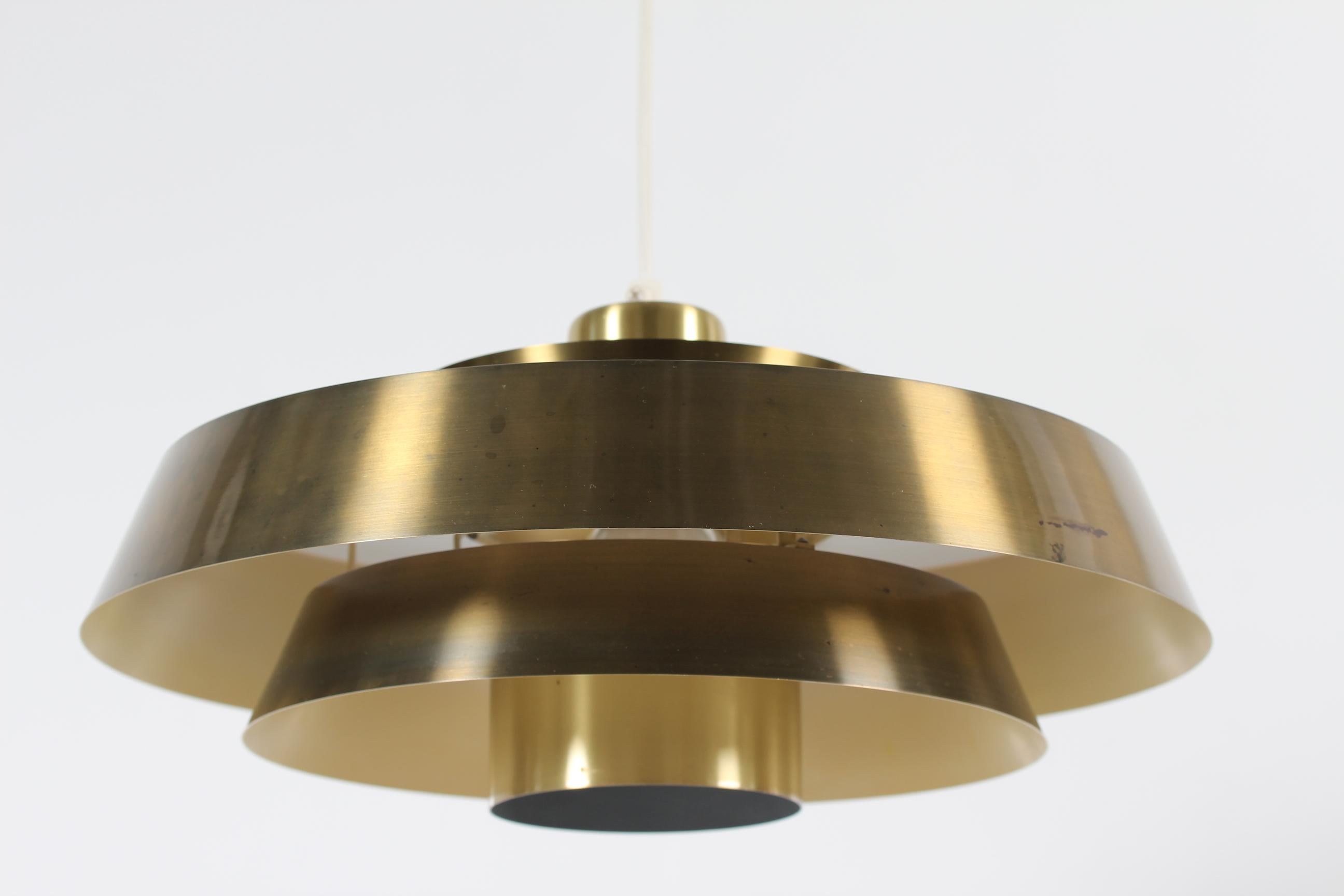 Original vintage Nova ceiling pendant designed by Danish designer Jo Hammerborg in the 1960´s.
It's made of brass, the inside is with white and light yellow lacquer.
The lamp is made by the Danish lamp manufacturer Fog & Mørup in Copenhagen in the