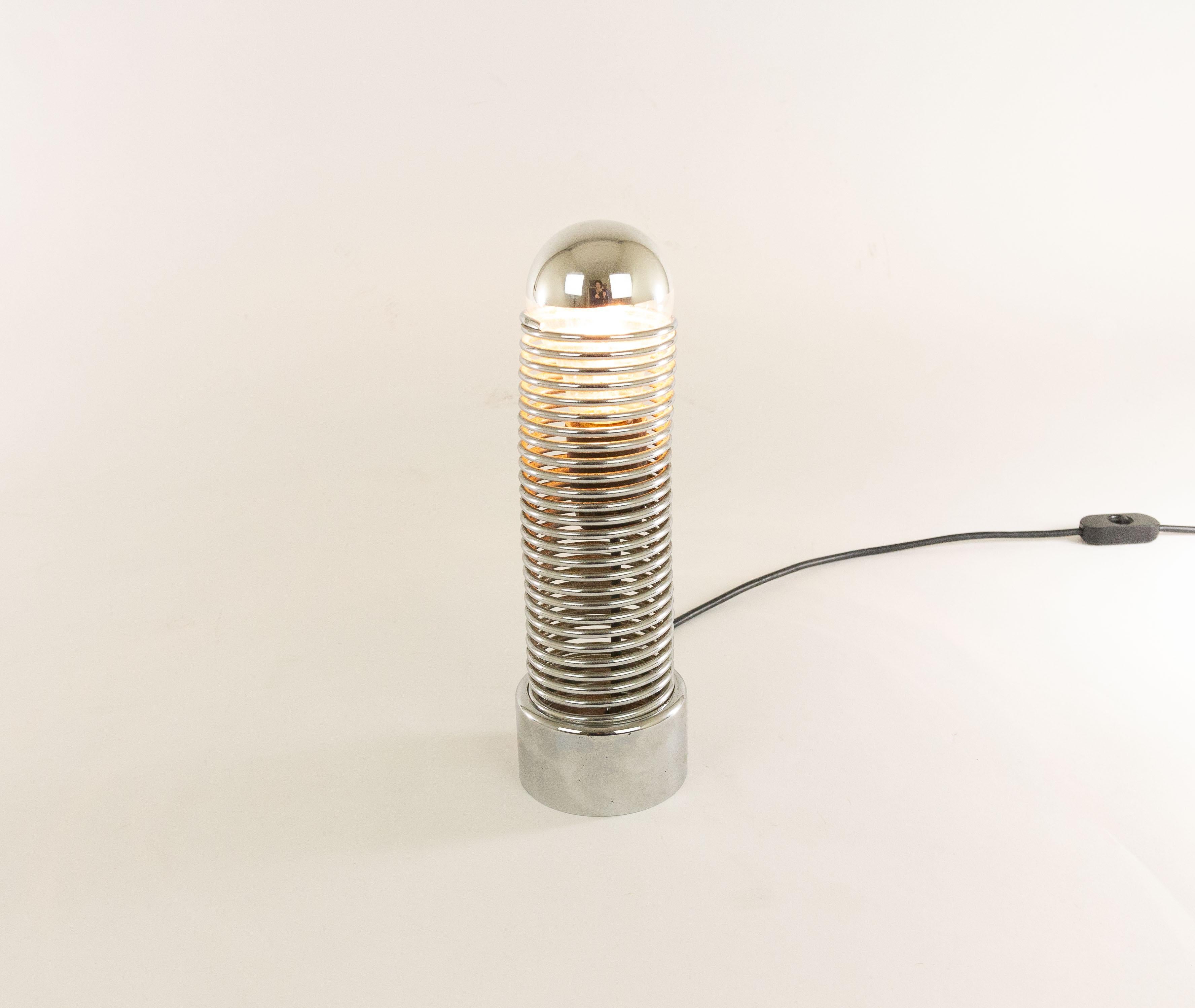 Jo-Jo table lamp designed by Heinz Brenker and produced by Harvey Guzzini, 1971. The lamp was in production from 1972-1974.

The lamp is made entirely of chrome-plated metal. The heavy base provides a counterbalance to the movable coil or spring
