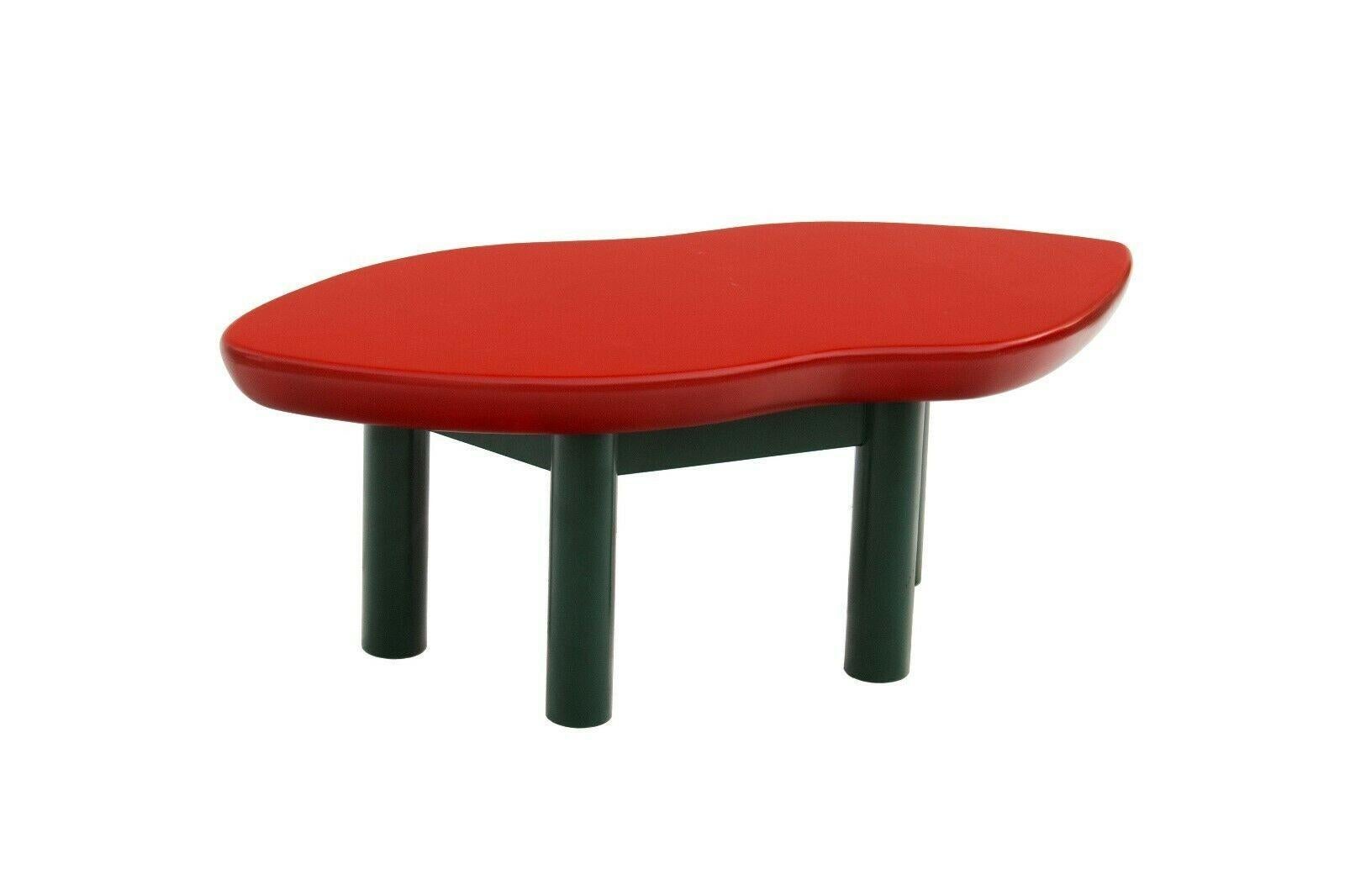 USA, 1980s
Joan Crawford lips coffee table, designed by Jay Spectre for Jay Spectre Inc. This is a smaller size for a cocktail table, yet also a very usable size. It has a glossy red lacquered lip-shaped top with hunter green lacquered legs. 
This