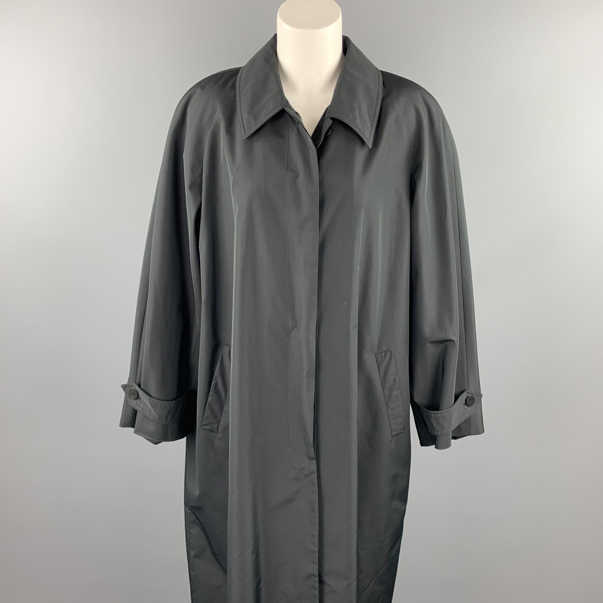 JOAN & DAVID long coat comes in a black polyester / silk with a full liner featuring a spread collar, slit pockets, and a hidden button closure. Made in Italy.

Very Good Pre-Owned Condition.
Marked: 42/8

Measurements:

Shoulder: 19 in. 
Bust: 44