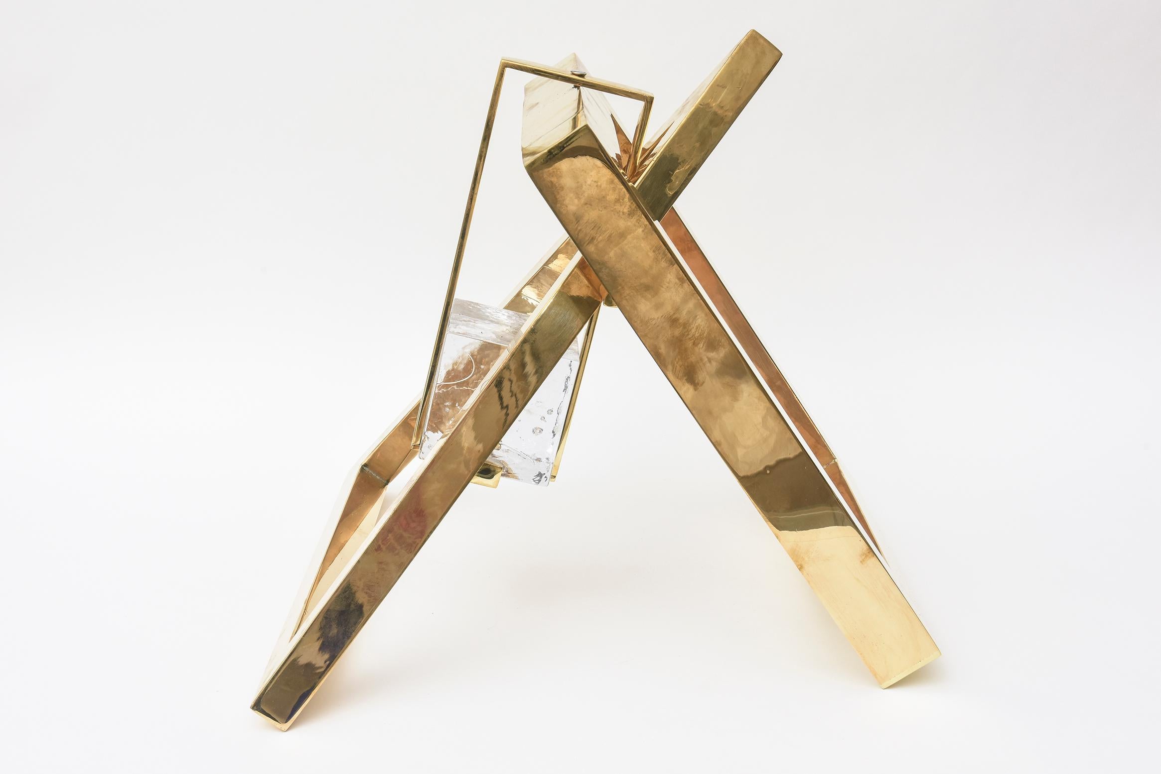 This amazing vintage sculpture by the noted glass artist and philanthropist Joan Lehman has forms of an inverted triangle and a square with a glass cube block suspended in the center and hanging. It is if there are 2 frames within each other of