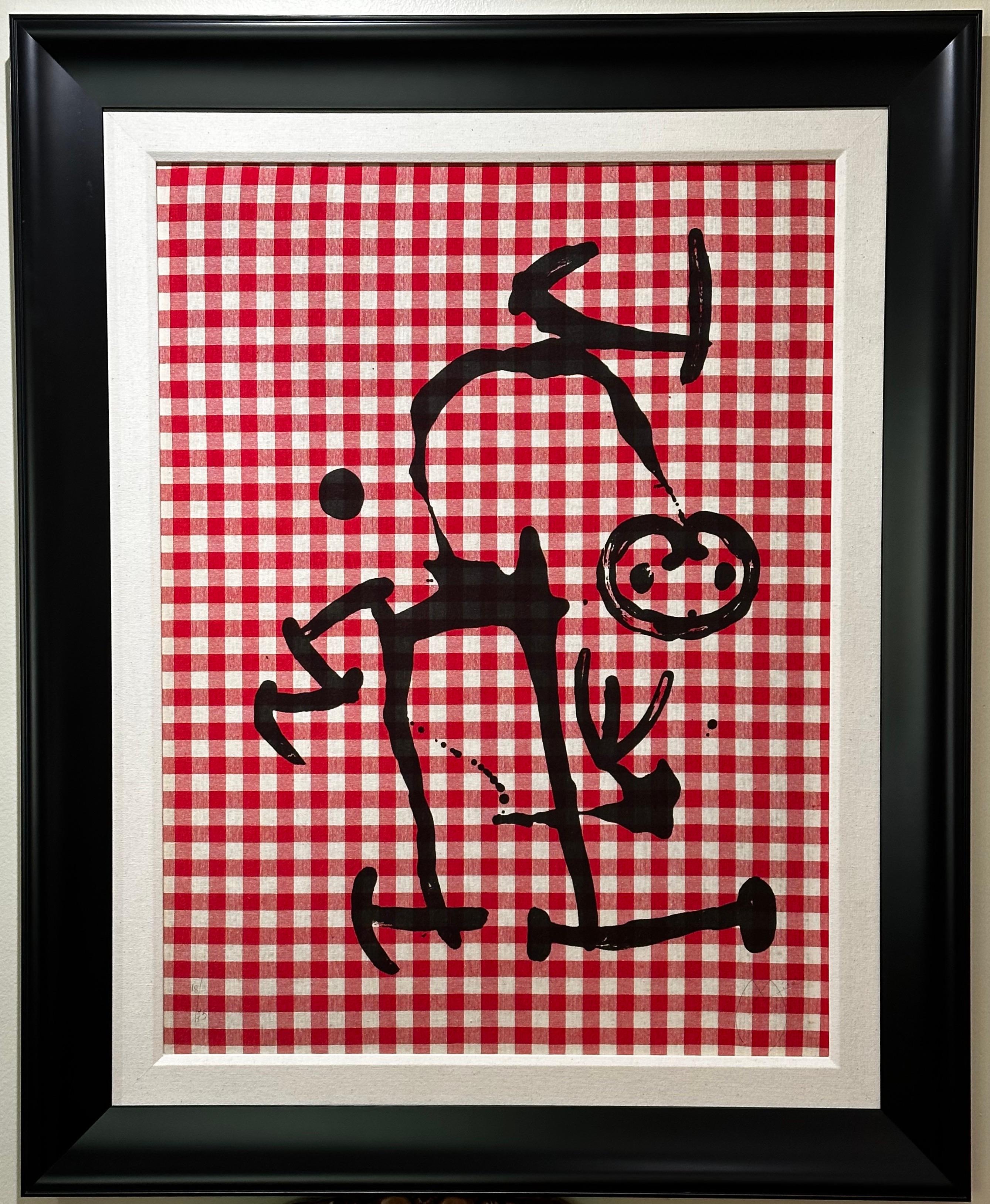 Artist: Joan Miro
Title: L'Illetre Aux Carreaux Rouges
Medium:  Color lithograph on red & white cloth on Mandeure Chiffon mounted on board
Size: 24.37 x 32.25 Inches 
Signed:  Hand Signed
Edition: 18/75
Publisher: Maeght, Paris
Reference: Mourlot