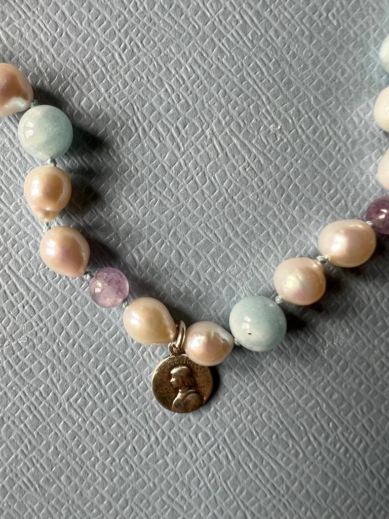 Joan of Arc Medal Necklace Aquamarine Amethyst White Pearl Beads Choker
Gold Filled Clasp

Length 16 inches, 41 Cm

Designer: J DAUPHIN 

Amethyst is celebrated for its stunning violet hues and its profound spiritual significance. It is often