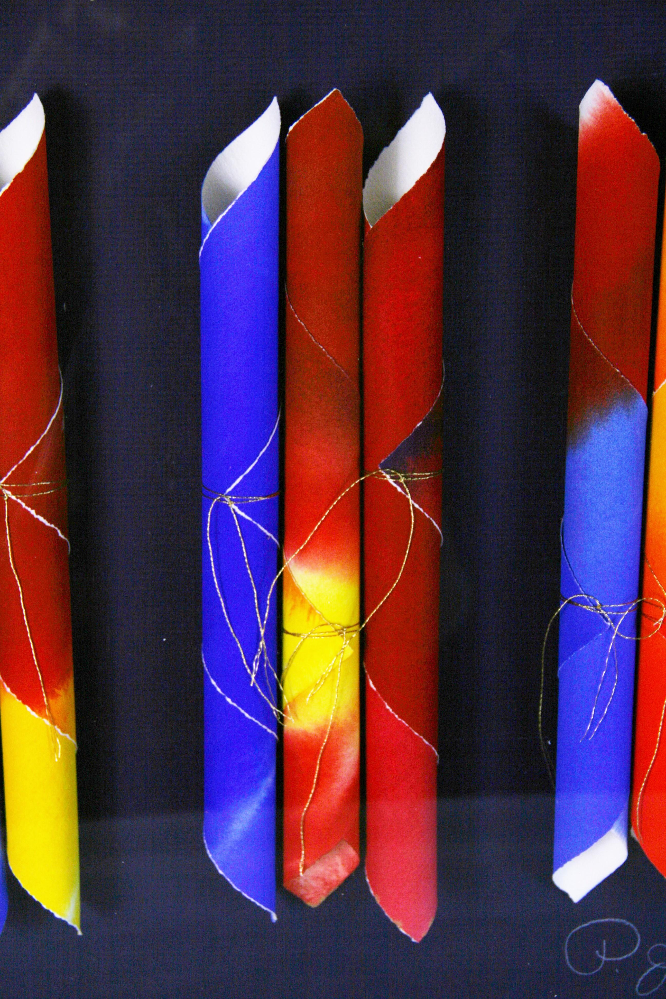 3991 Sculptural Art piece rolled archival acrylic painted paper set in a custom acrylic frame on dark blue back round