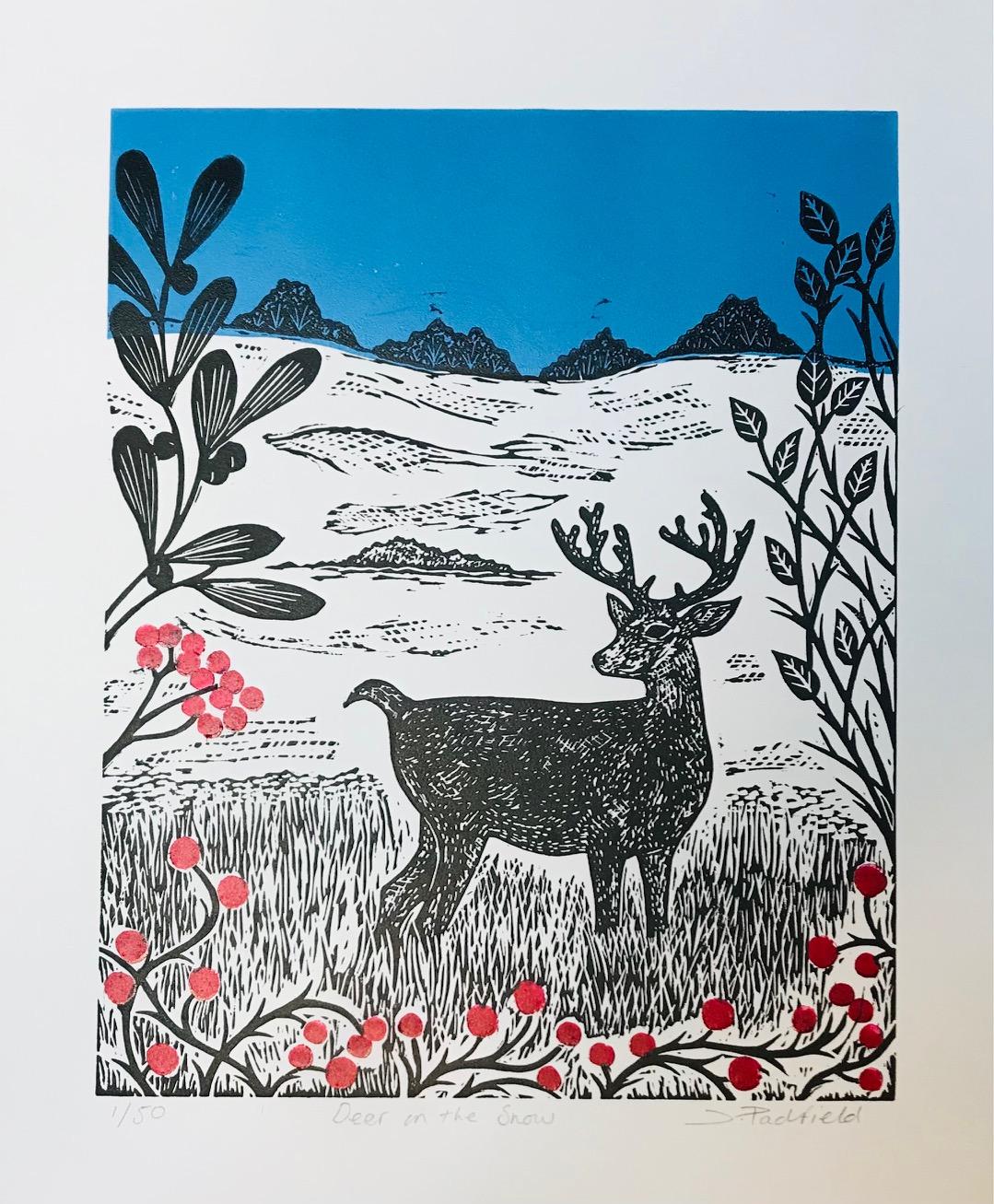 Deer in the Snow is a limited edition, multi block, linocut print of a Roe Deer standing in the snow. Surrounding the deer are deep red berries, Mistletoe and winter leaves. There are trees in the distance and a blue sky. The inspiration for this