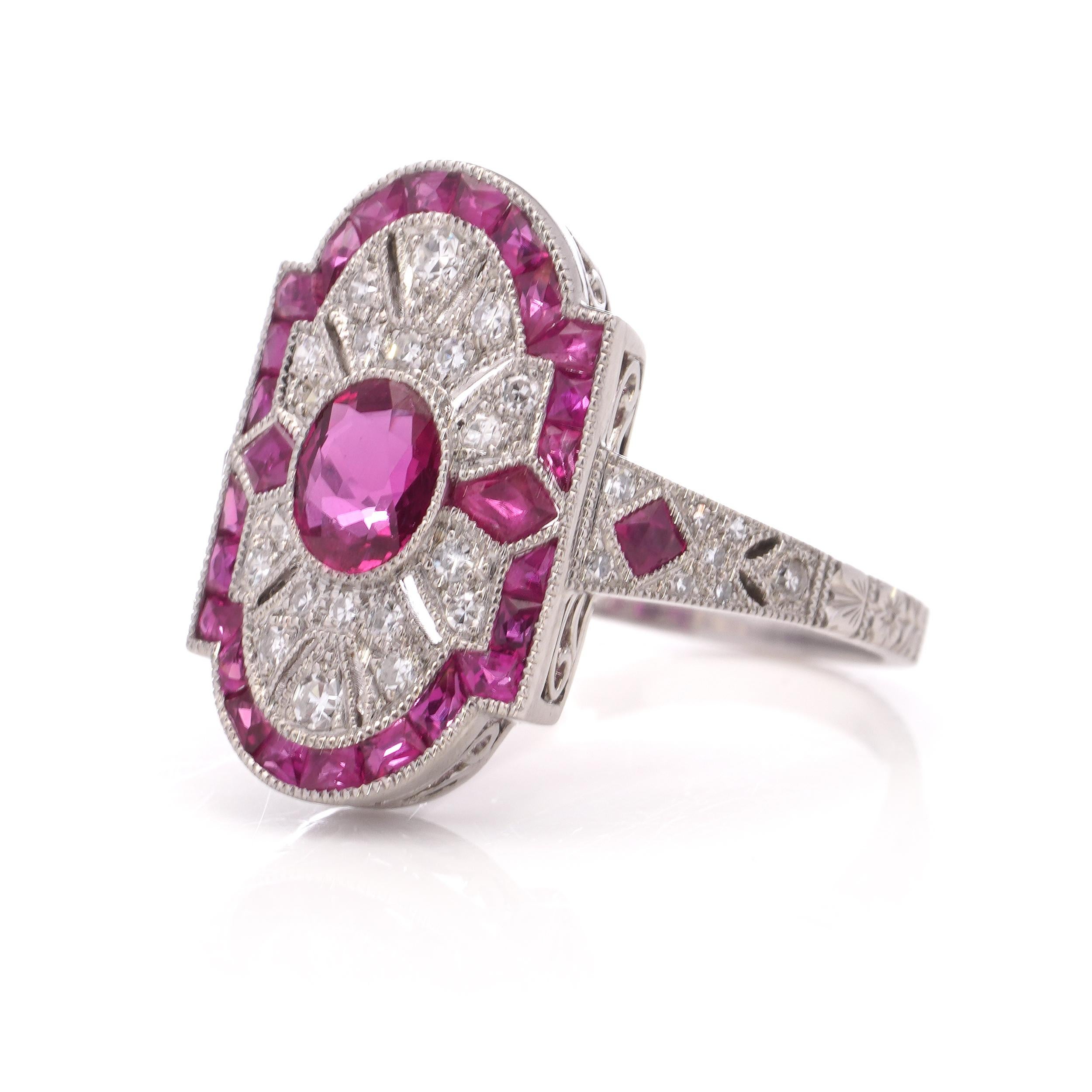 JoAq 850 Platinum Art Deco-inspired ruby cluster ring surrounded by round brilliant cut diamonds. 

Made in After 2000
Maker: JoAq 
Hallmarked for .850 platinum purity. 

Dimensions - 
Finger Size (UK) = L 1/2 (EU) = 53.5 (US) = 6.25
Weight: 5.2