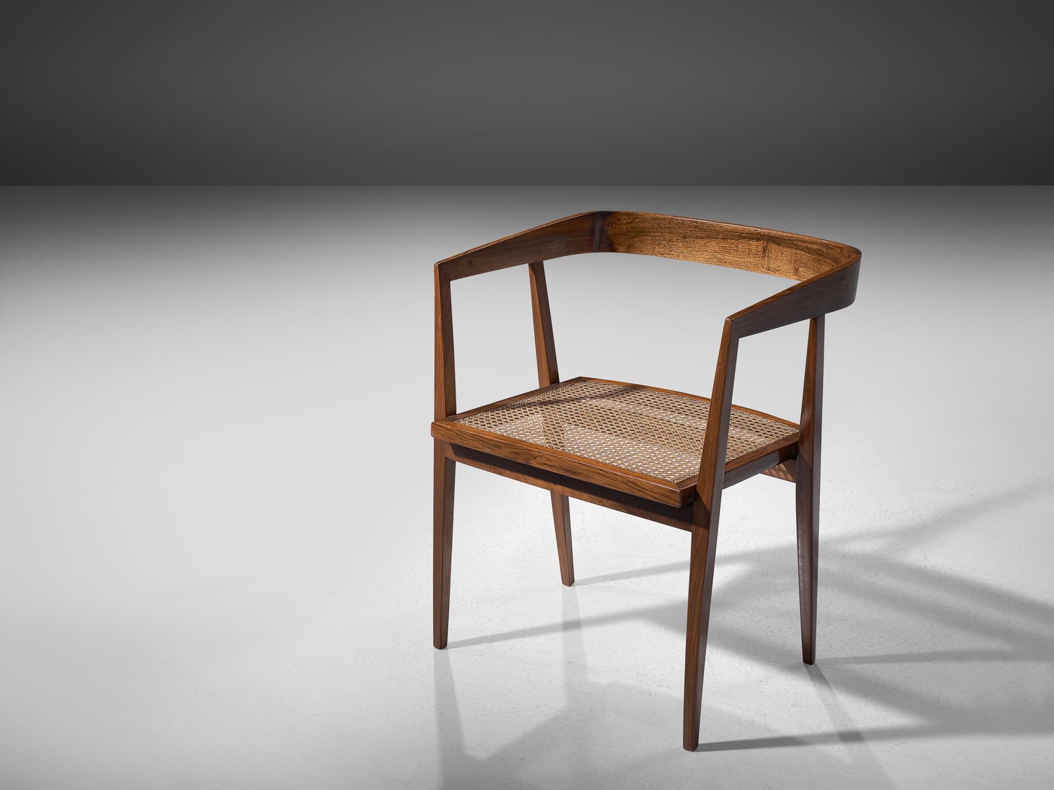 Joaquim Tenreiro, armchair, rosewood, cane, Brazil, circa 1960

An exceptional chair designed by the Brazilian master designer and woodworker Joaquim Tenreiro. The armchairs main feature is its wide, luxurious cane seat and light, open