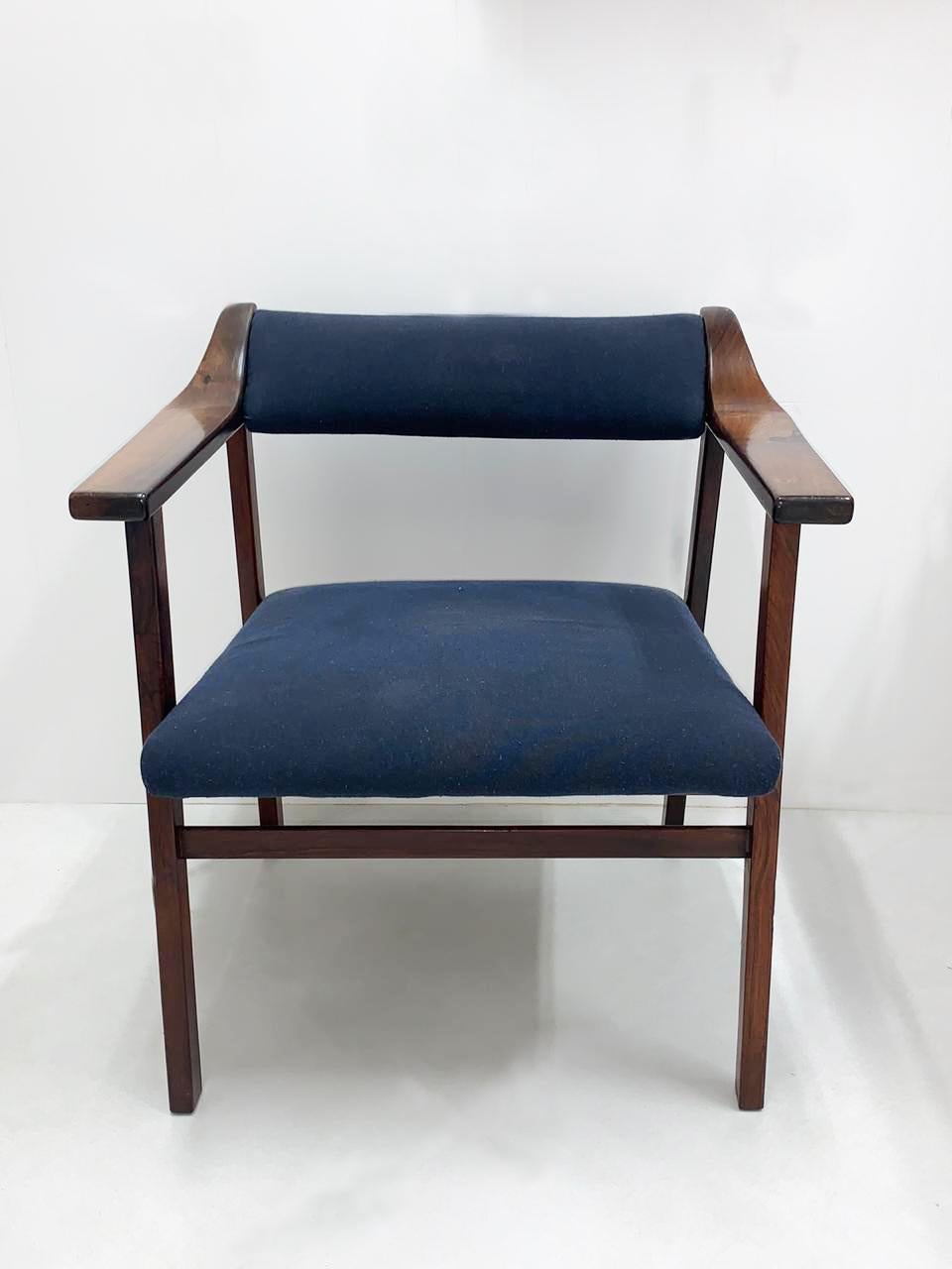 Mid-Century Modern armchair attributed to the Brazilian master designer Joaquim Tenreiro. This lounge chair is made of solid rosewood in the 1960's with a new reupholstered blue covering. A total of 2 are available.