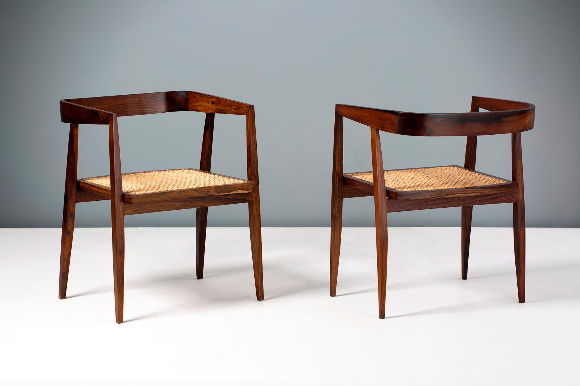 Joaquim Tenreiro 

(Brazilian, 1906-1992) 

Pair of armchairs produced in Pau Ferro wood (Santos Rosewood) and cane in the 1960s.

One of Tenreiro's most collectible and sought after chairs. This example is in immaculate condition with no