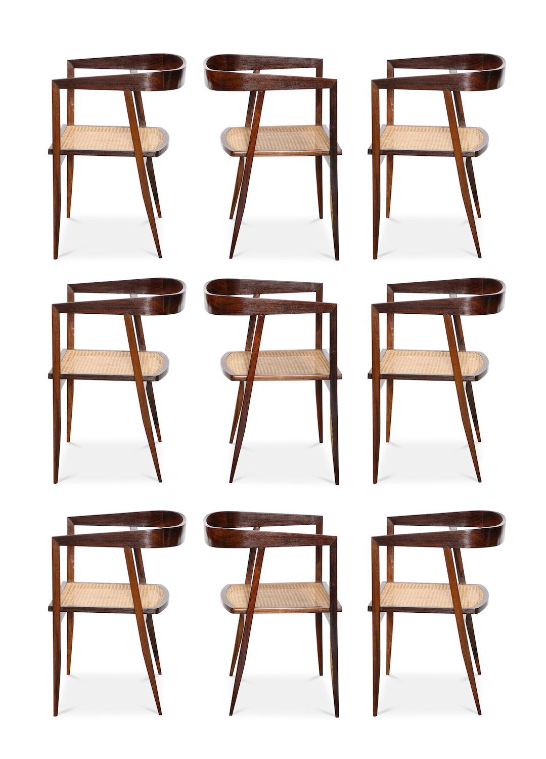 Joaquim Tenreiro rare set of 9 armchairs. A complete set of dining chairs by this Brazilian master. Minimal and sculptural design. Jacaranda frames with sturdy rattan seats.