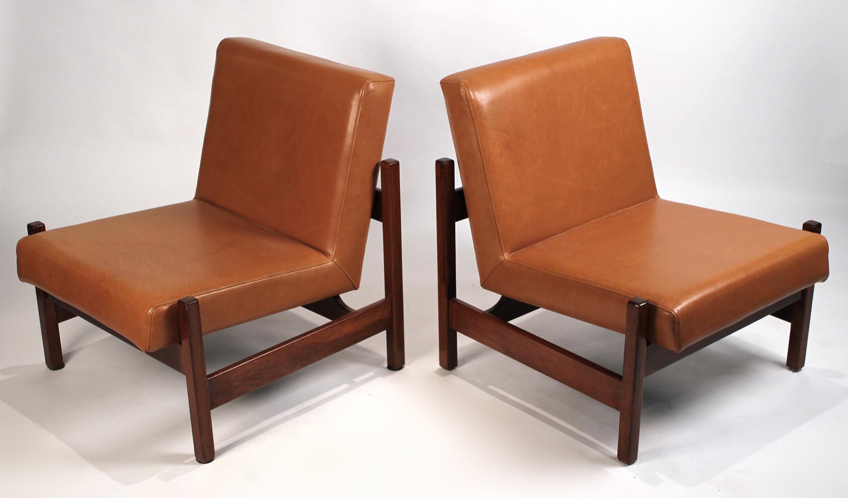 A pair of Peroba wood chairs upholstered in a rich caramel leather. Forma distributed and produced many designs by Knoll in the 1960s. These are essentially Brazilian Knoll chairs as some of the pieces sold by Forma shared both a Forma and a Knoll