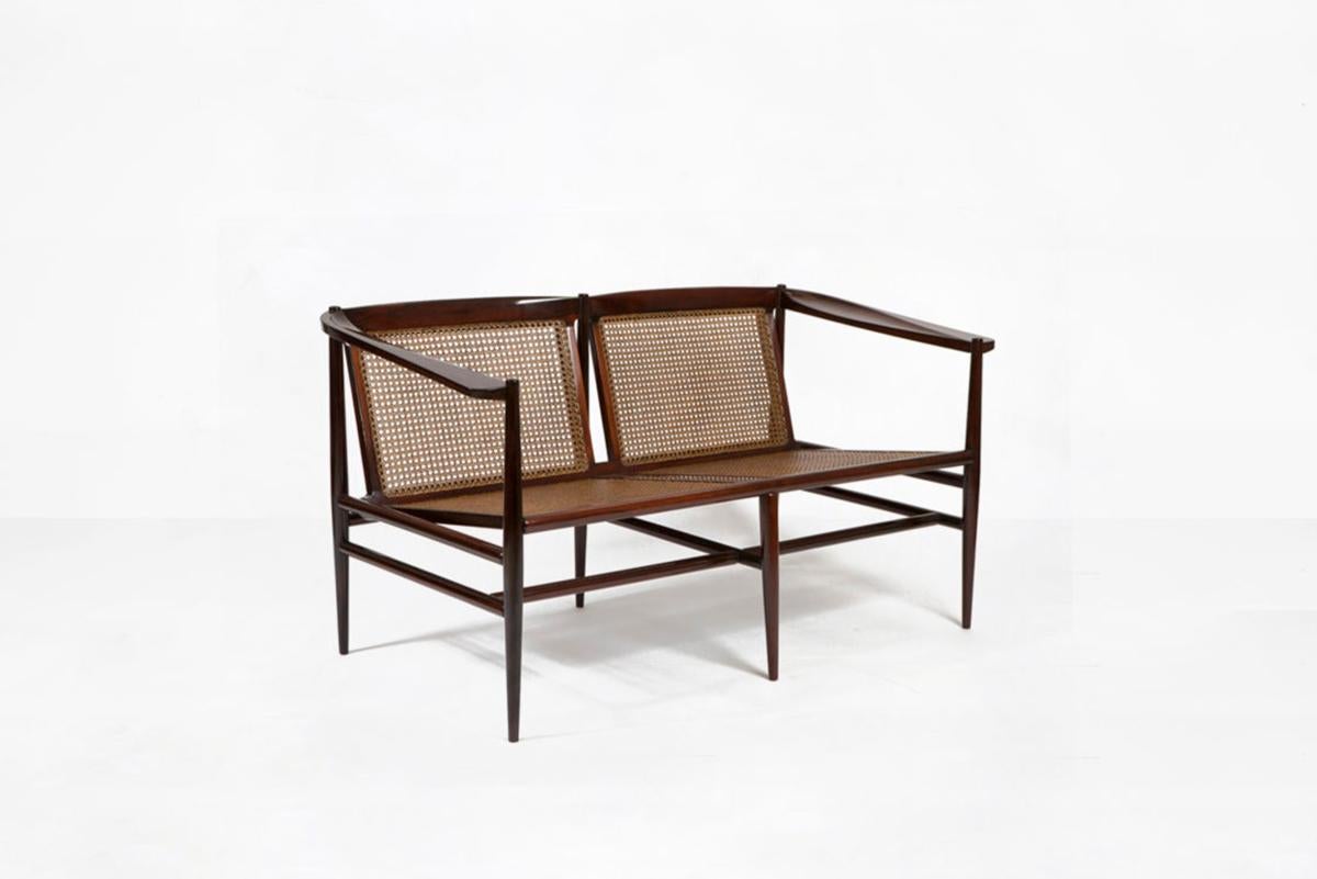 Joaquim Tenreiro
Two seats bench
Manufactured by Tenreiro Moveis e Decoraçaos
Brasil, 1958
Jacaranda wood, cane
From the archives of Side Gallery, Barcelona 
 
Measurements
120 cm x 50 cm x 71 H cm
47.24 in x 19.68 in x 28.95 H