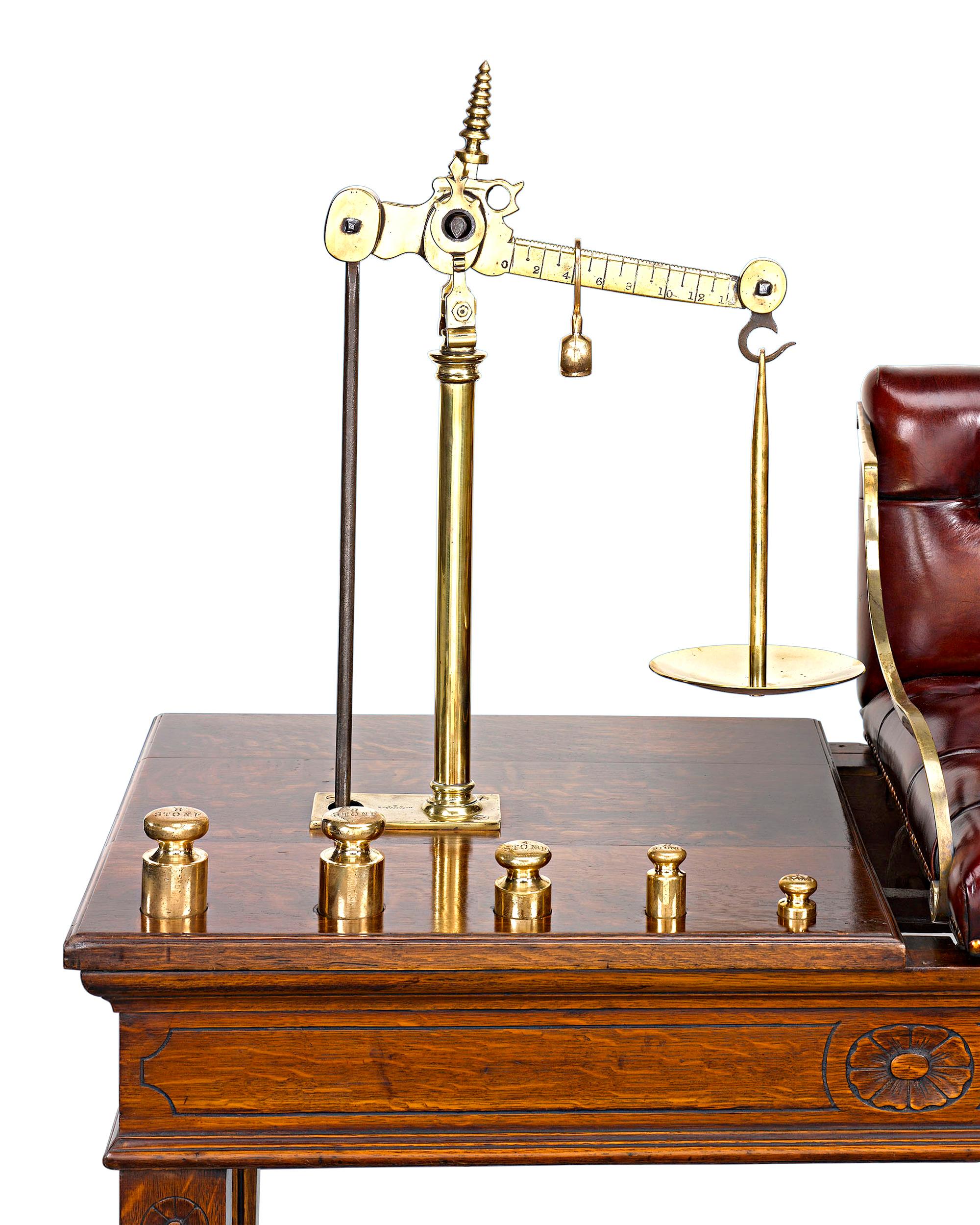 This handsome English solid oak jockey scale retains its original tufted leather seat and solid brass weights by W. Thornhill of London. These beautiful scales were used at English tracks to determine the jockey’s weight before a big race. This was