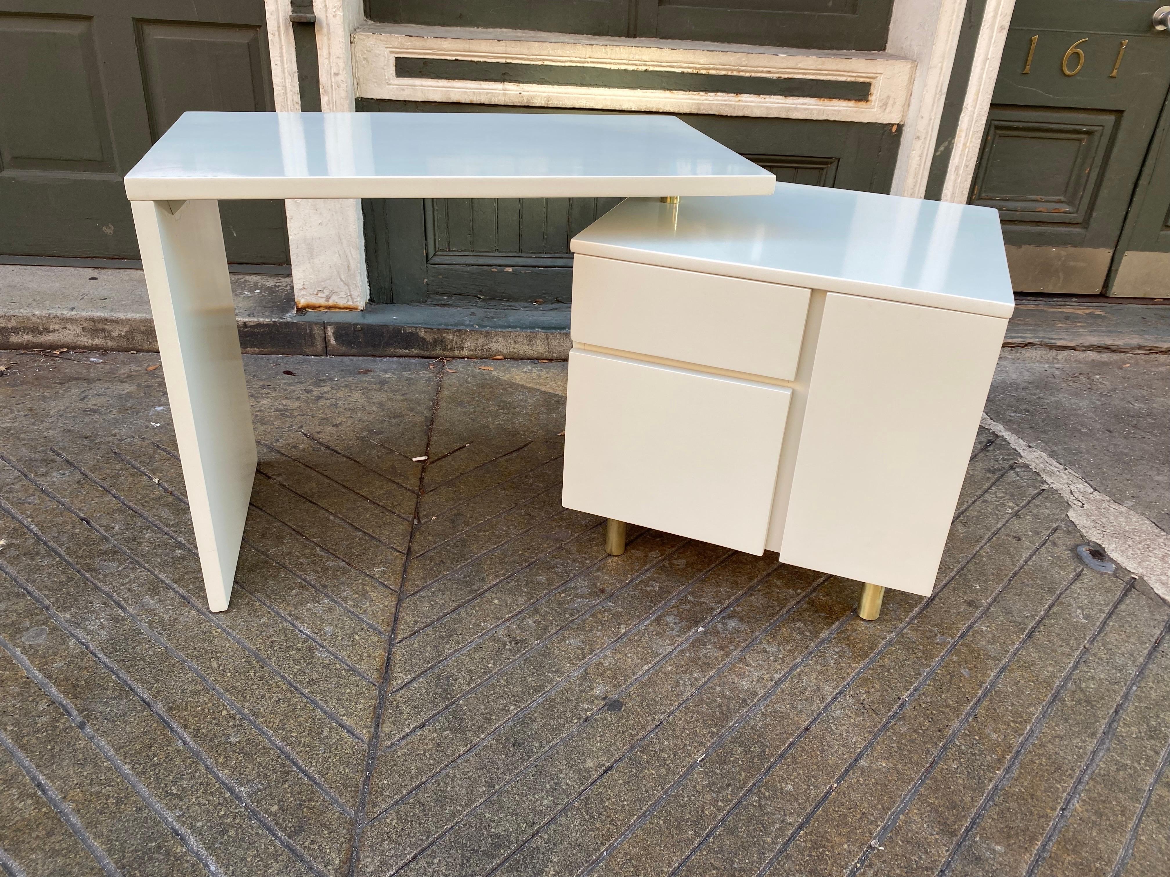 Joe Atkinson for Thonet 2-part swinging/pivoting desk. Clever design that allows you to pivot and angle the work surface away from the storage Cube. Newly redone in a creamy olive color. Brass legs and pivot adds a nice look to this desk. One door