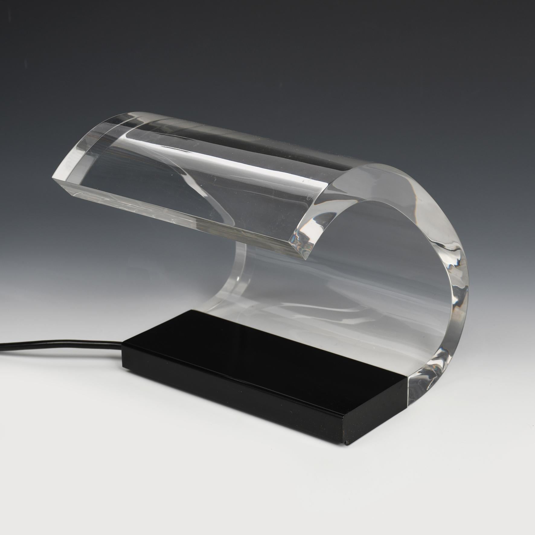 A table lamp with a black lacquered metal base issuing a Perspex diffuser. 
Manufactured by Oluce, Milan.
Italy.
Created in 1964. 
This model produced in 1985. With a certificate of guarantee dated of April 1985.


Literature
Domus, n°421, December