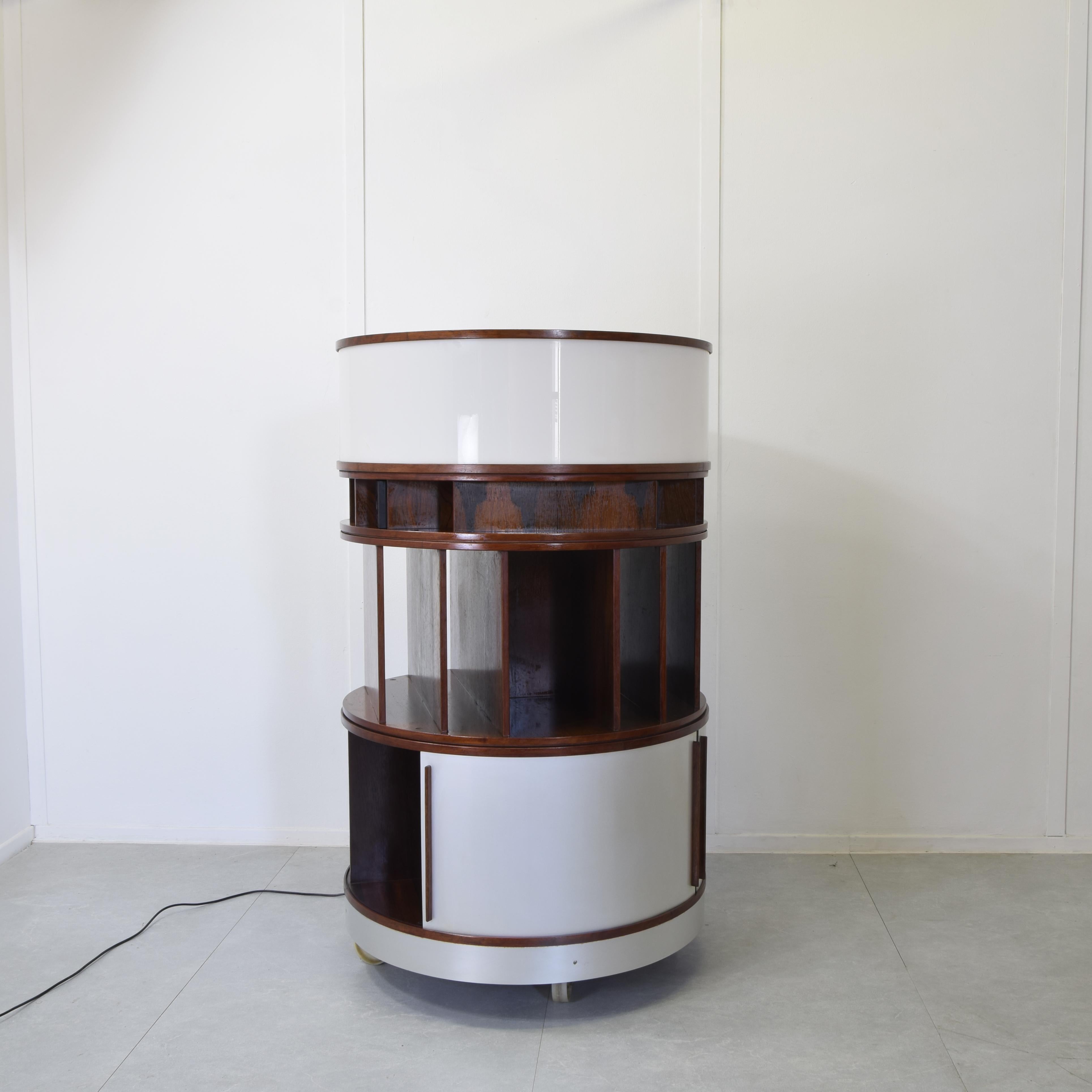 Storage unit from the Combi Center series, stackable element system with wooden frame, aluminium sliding panels and light level with perspex diffuser. Mahogany wood, aluminium, mirrored glass, painted metal, opaline perspex. Production Bernini 1963
