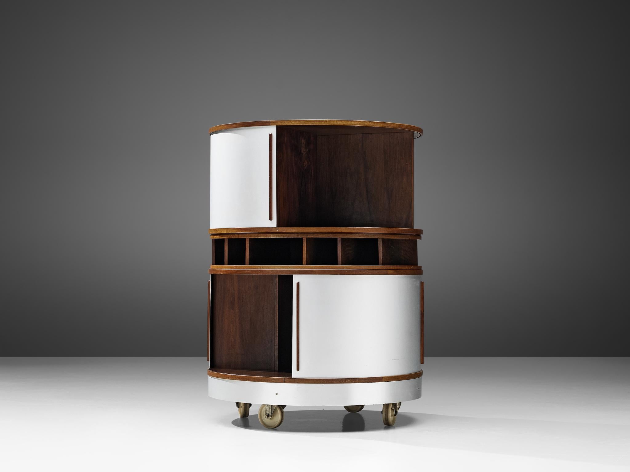 Joe Colombo for Bernini, 'Combi Center' trolley, plywood, aluminum, plastic, Italy, circa 1963.

A cylindrical storage unit on wheels, designed by Joe Colombo in circa 1963. The Space Age case piece features curvaceous, functional forms with