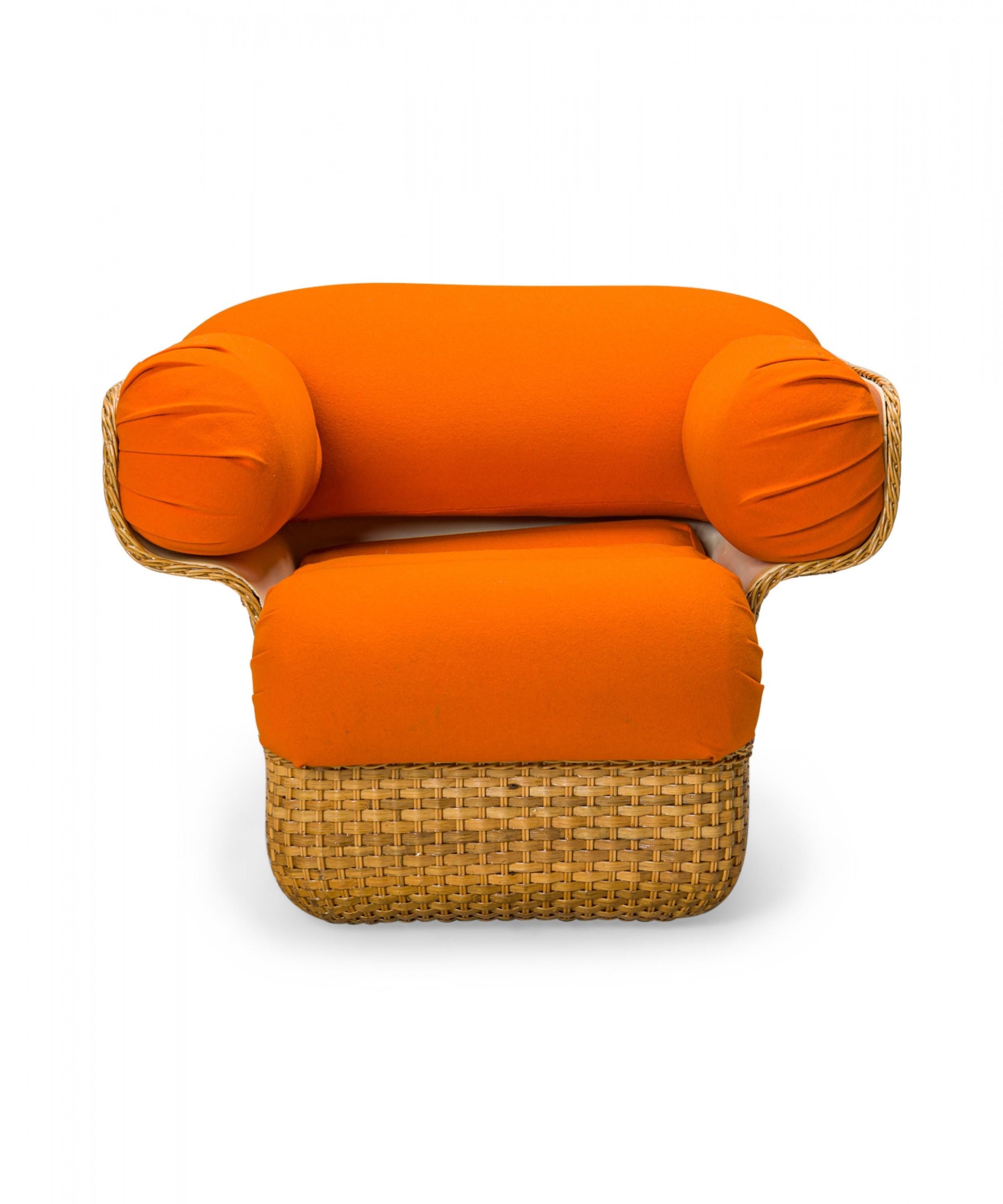 Italian mid-century lounge / armchair with a small woven wicker form with large cylindrical bright orange cushions, resting on a wicker pedestal base. (Joe Colombo).