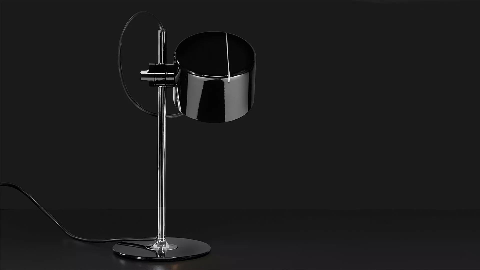 Joe Colombo Model #2201 'Mini Coupé' table lamp in black for Oluce. 

Executed in black enameled metal and chrome, this table lamp is a smaller-scale version of one of the most refined Minimalist Italian designs of the midcentury and an icon for