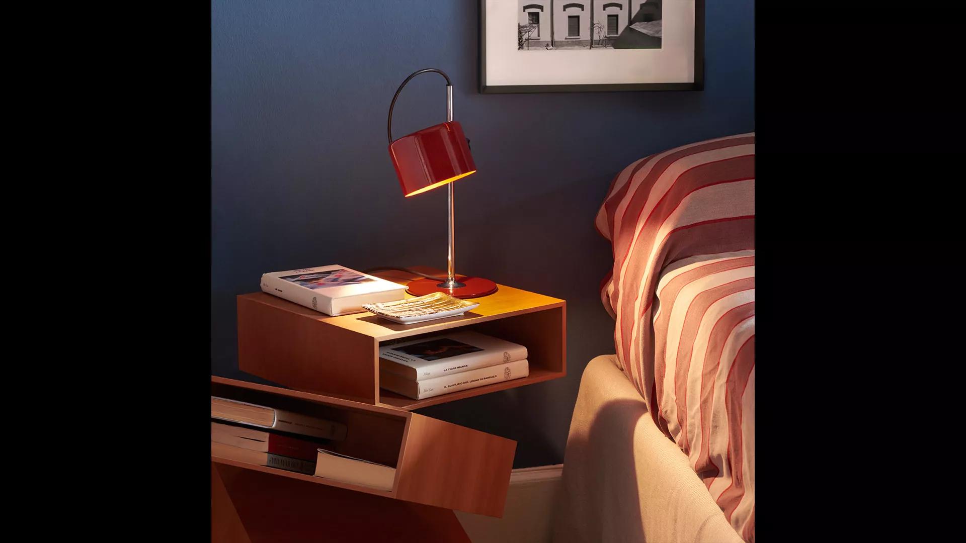 Joe Colombo Model #2202 'Coupé' table lamp in scarlet red for Oluce. 

Originally designed in 1967, this is one of the most refined Minimalist Italian designs of the midcentury and an icon for Colombo. A highly adjustable table light, the shade can