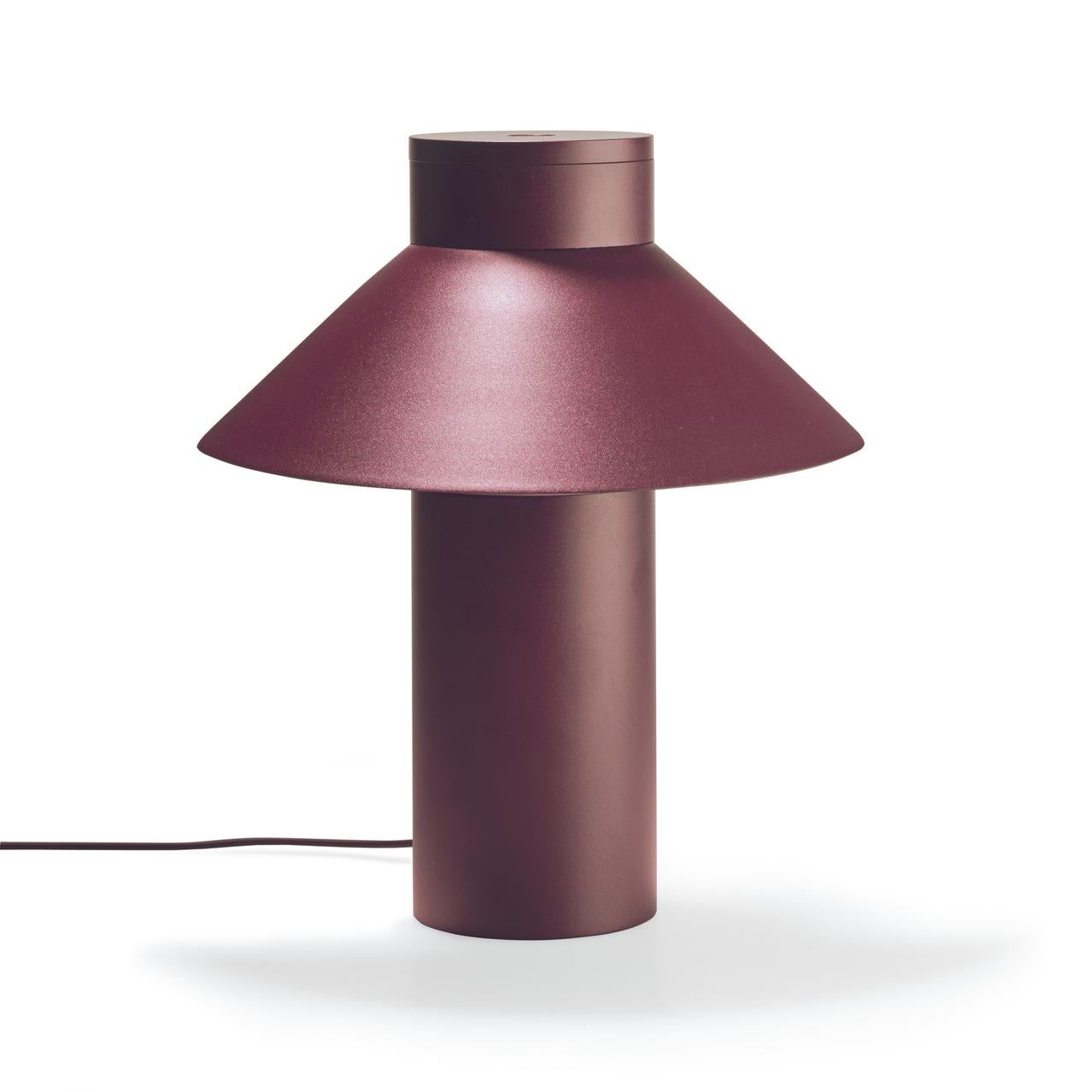 Table Lamp designed by Joe Colombo in 1968. 

With its sleek yet optimistic clarity of form; a light, triangular shade seemingly floating off a weighty cylindric base, Italian design icon Joe Colombo’s table lamp nods to Asian heritage, the name