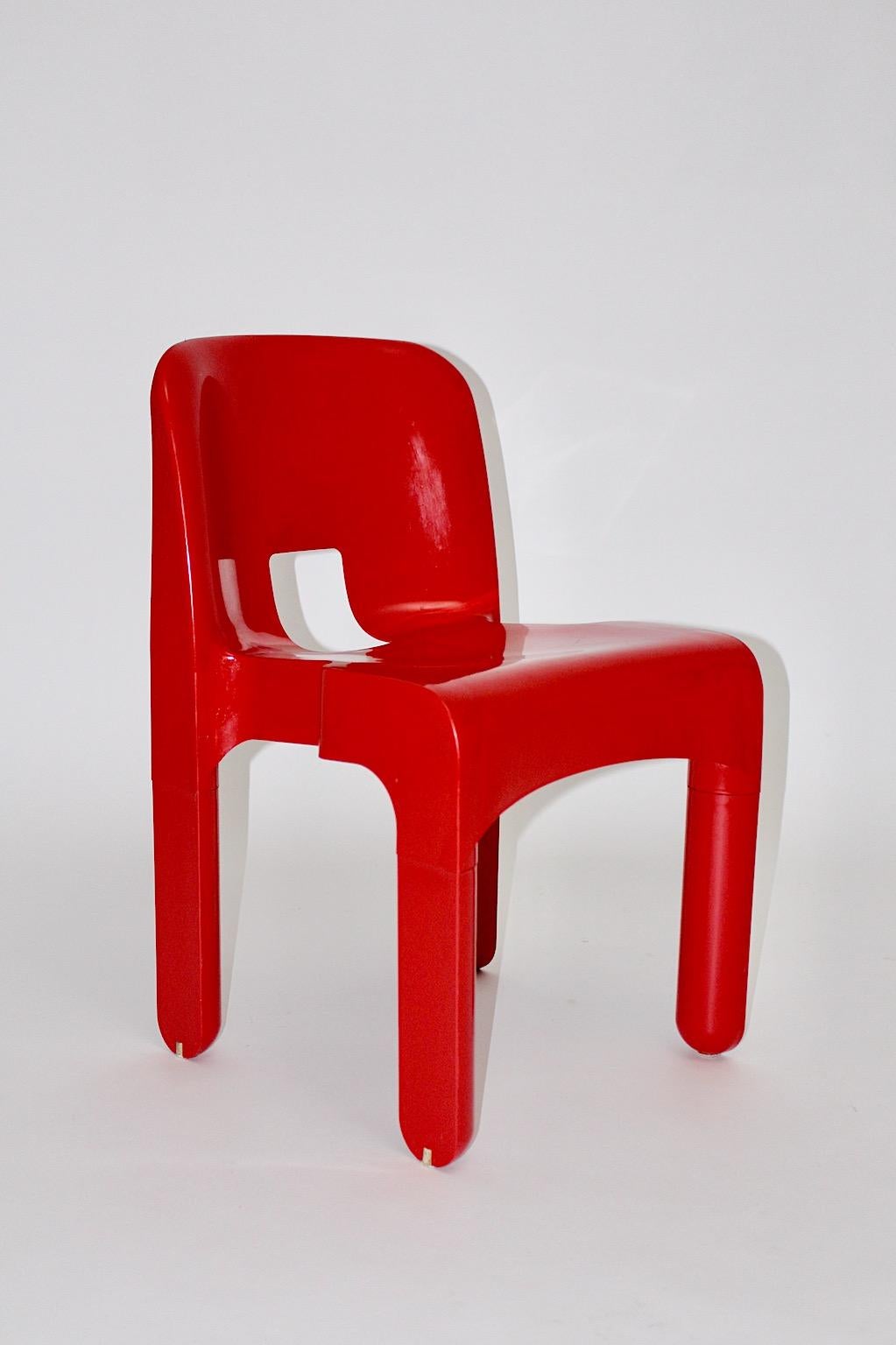 Joe Colombo Space Age red vintage plastic chair, which was designed 1965 - 1967 Italy named Model 4869 Universale and produced by Kartell Milano.
The chair model Universale is labeled underneath.
Joe Colombo (1930-1971) created in his short career