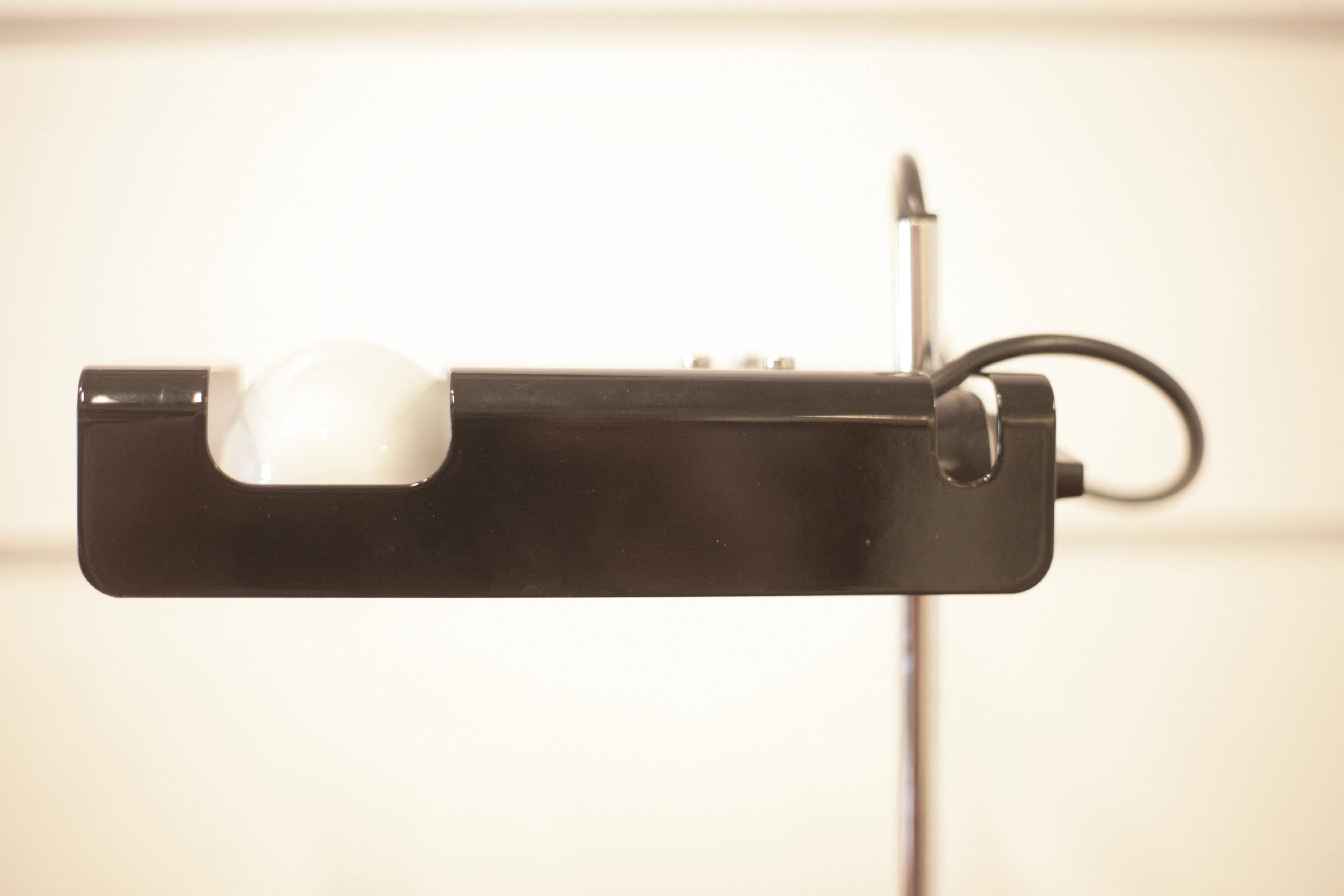 A black desk lamp designed by Joe Colombo in 1965. Stove-enameled sheet metal reflector purposely designed to take a special horizontal spot light bulb. In 1967 Spider won the Compasso d’Oro award. It is part of the permanent collections of the