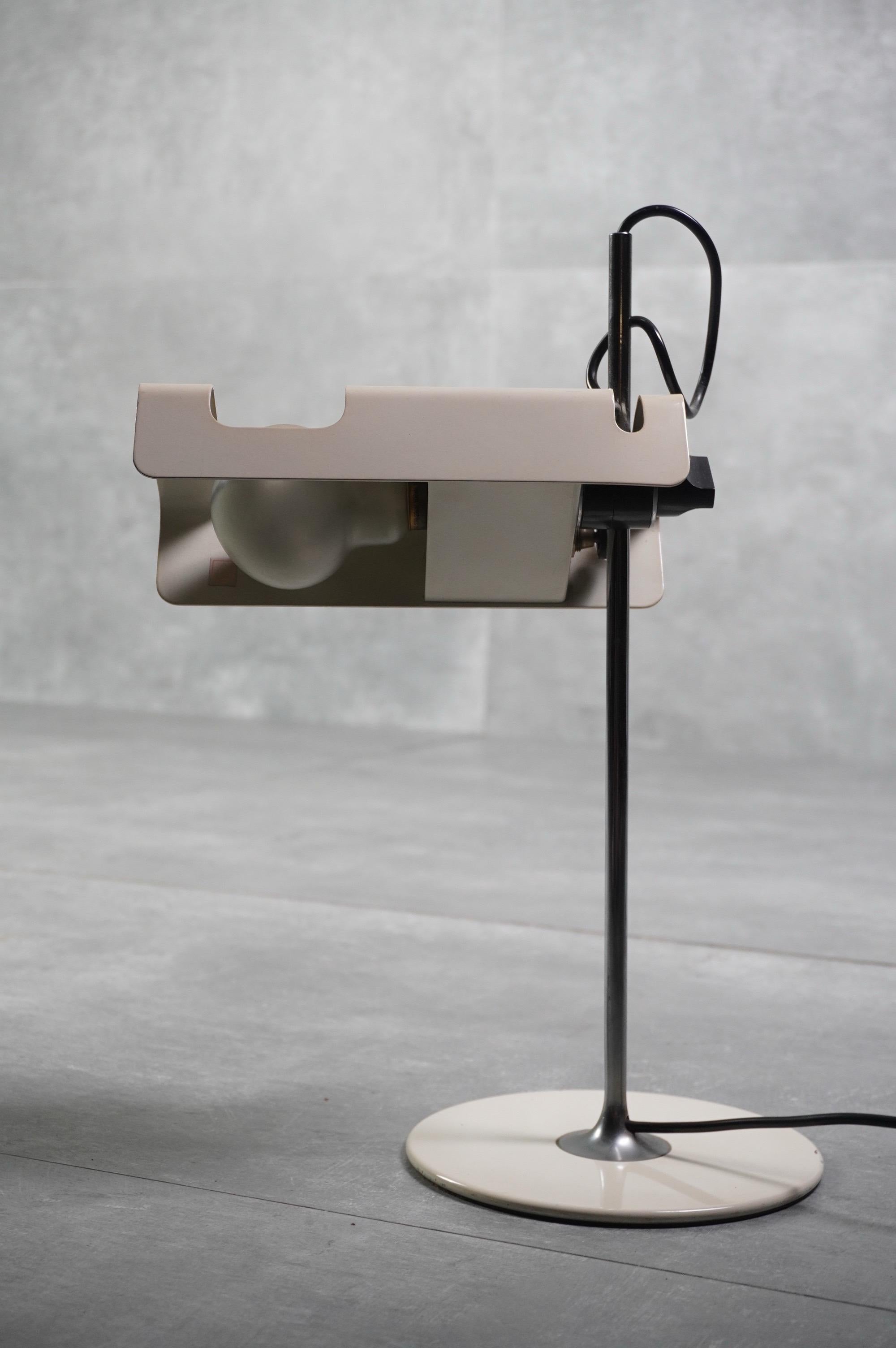 Iconic ''Spider'' table lamp designed by Joe Colombo for Oluce in 1965. This version features a lacquered white metal reflector, chrome stem , and cast iron base, maintenenig the clean, futuristic aesthetic Colombo was known for. The adjustable head